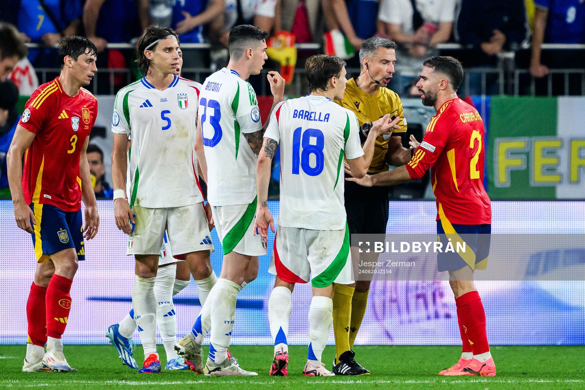 Alessandro Bastoni and Nicolo Barella of Italy with Referee