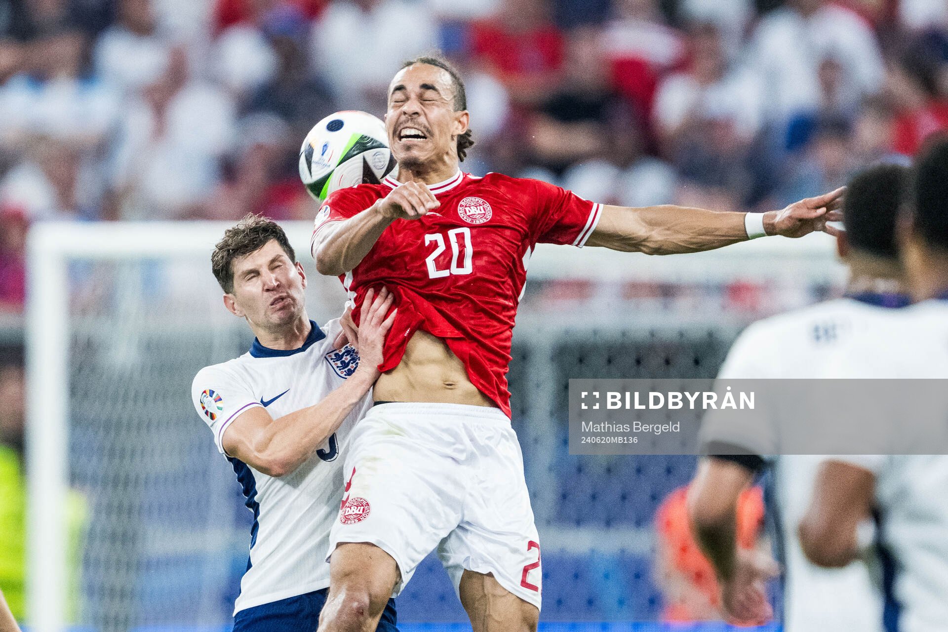 John Stones of England and Yussuf Poulsen of Denmark