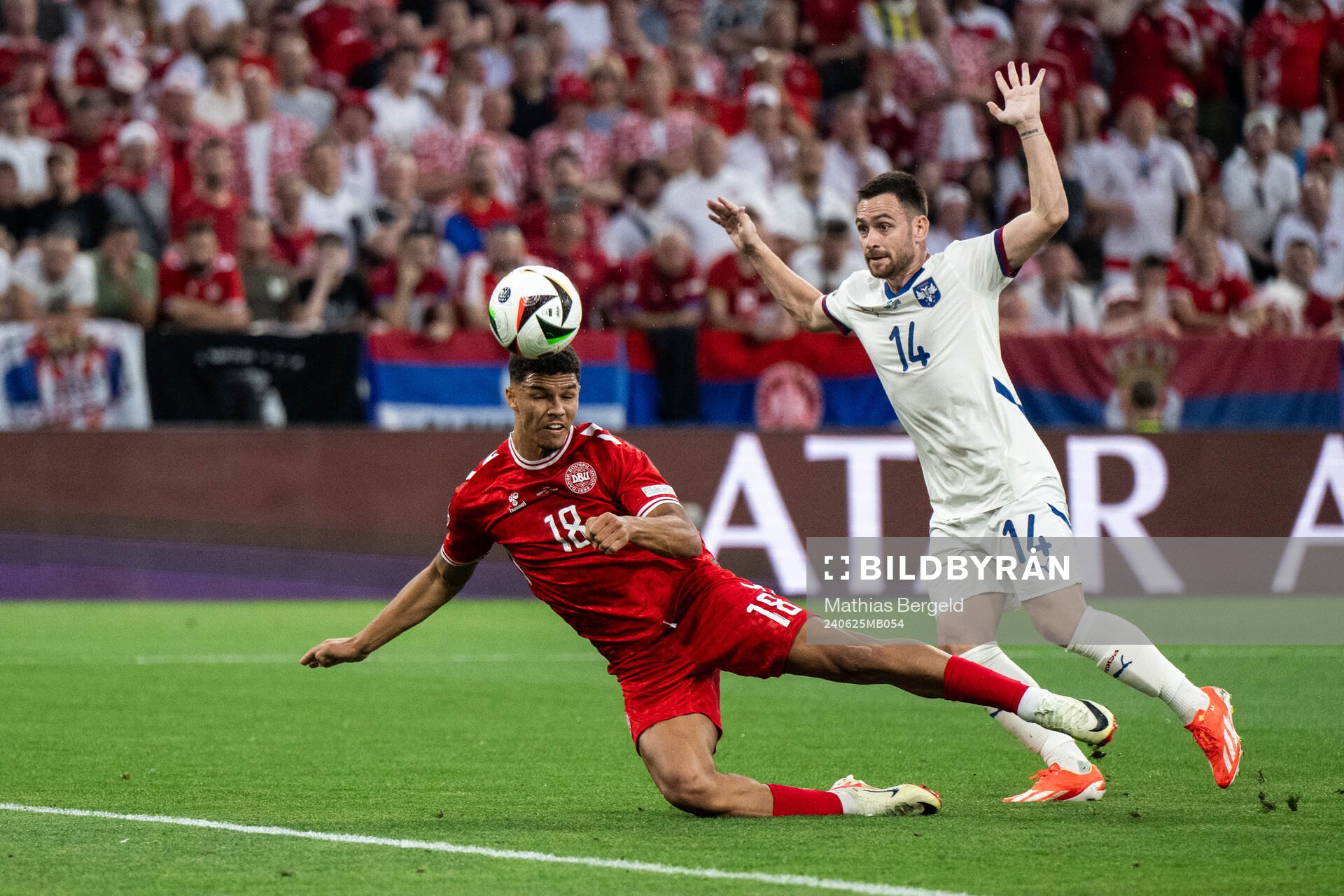 Alexander Bah of Denmark and Andrija Zivkovic of Serbia during the UEFA Euro 2024 Football Championship match between Denmark and Serbia on June 25, 2024 in Munich.