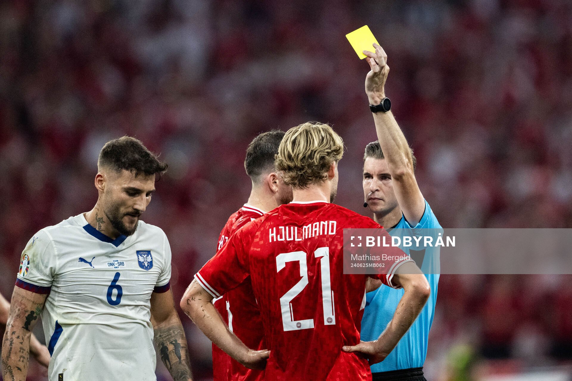 Morten Hjulmand of Denmark receives a yellow card from