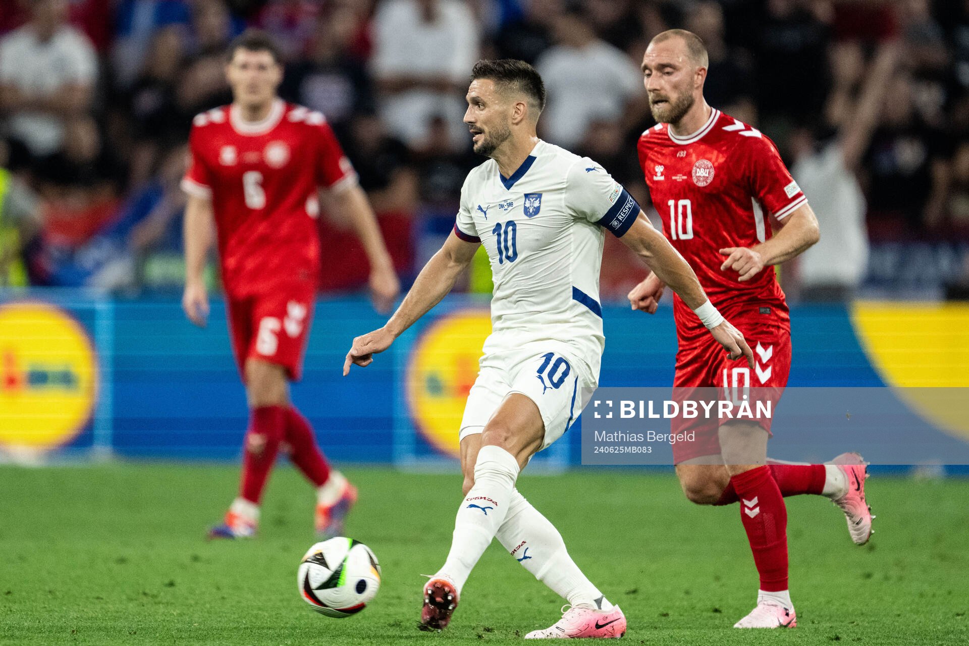 Dusan Tadic of Serbia and Christian Eriksen of Denmark