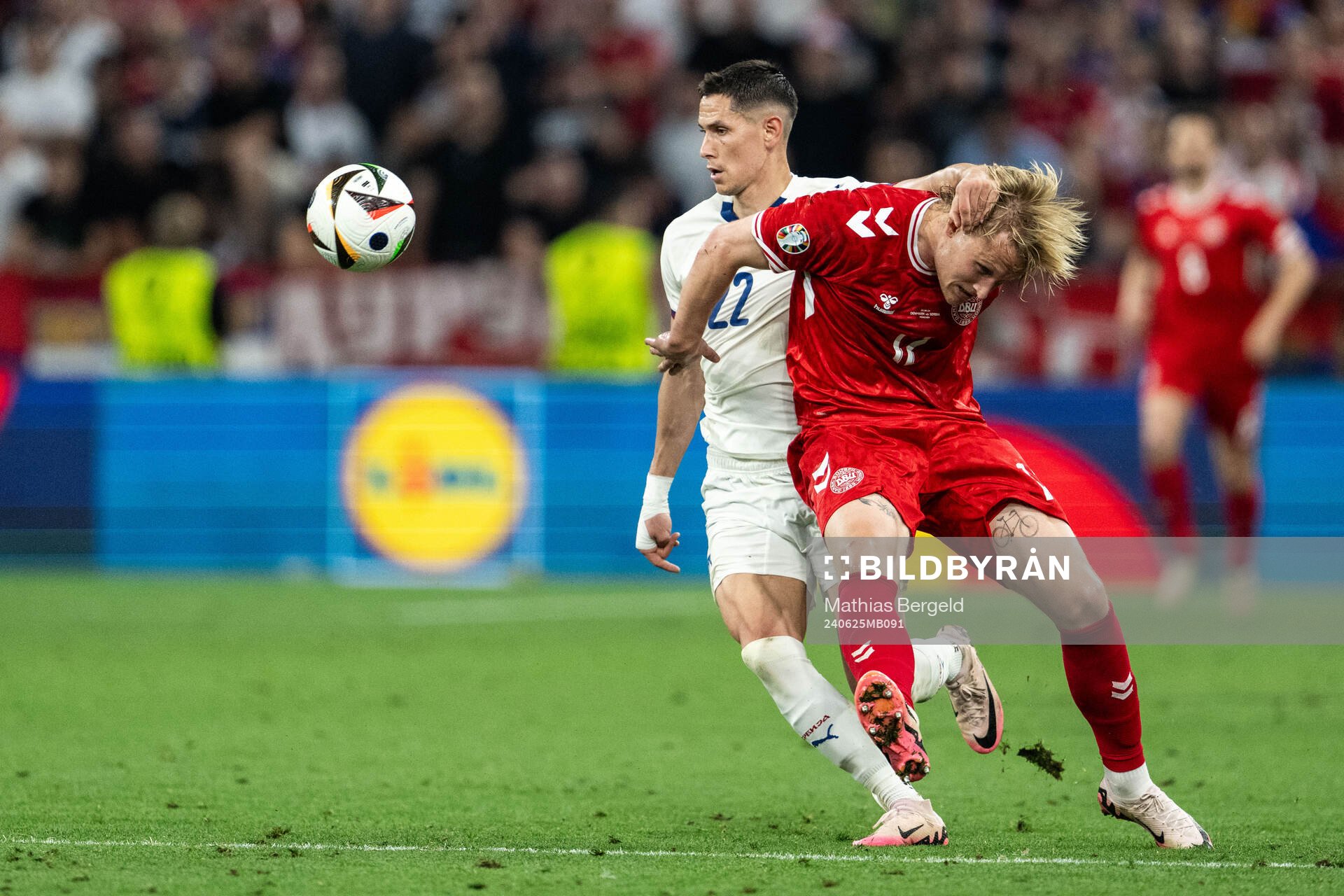 Sasa Lukic of Serbia and Kasper Dolberg of Denmark during the UEFA Euro 2024 Football Championship match between Denmark and Serbia on June 25, 2024 in Munich. 