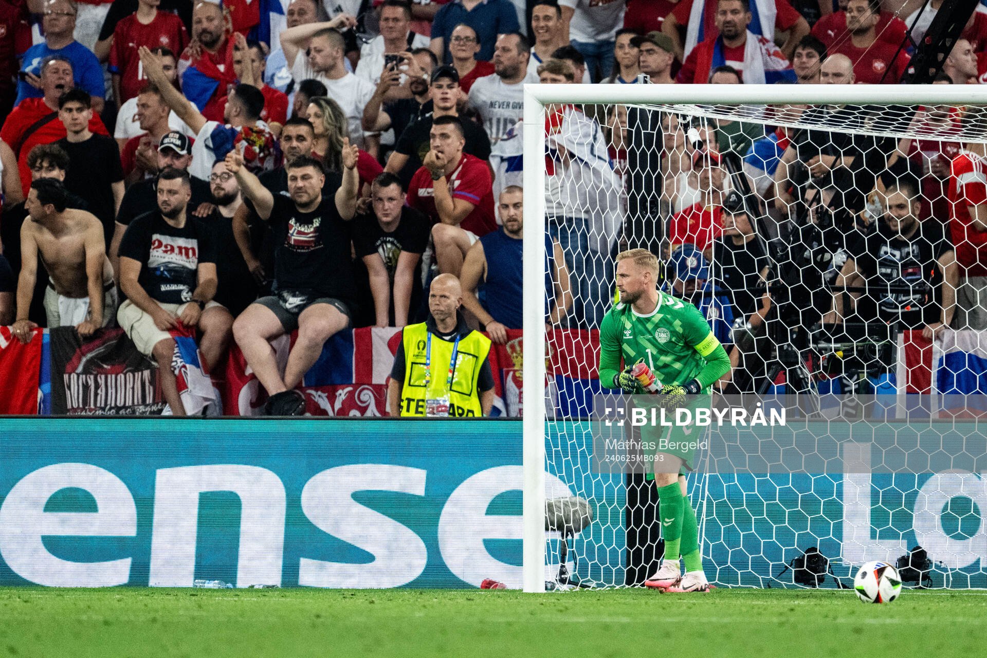 Goalkeeper Kasper Schmeichel of Denmark picking up plastic