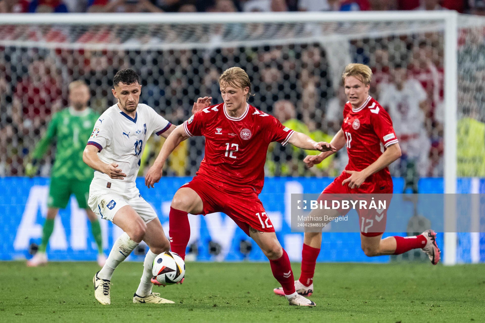Milos Veljkovic of Serbia and Kasper Dolberg of Denmark