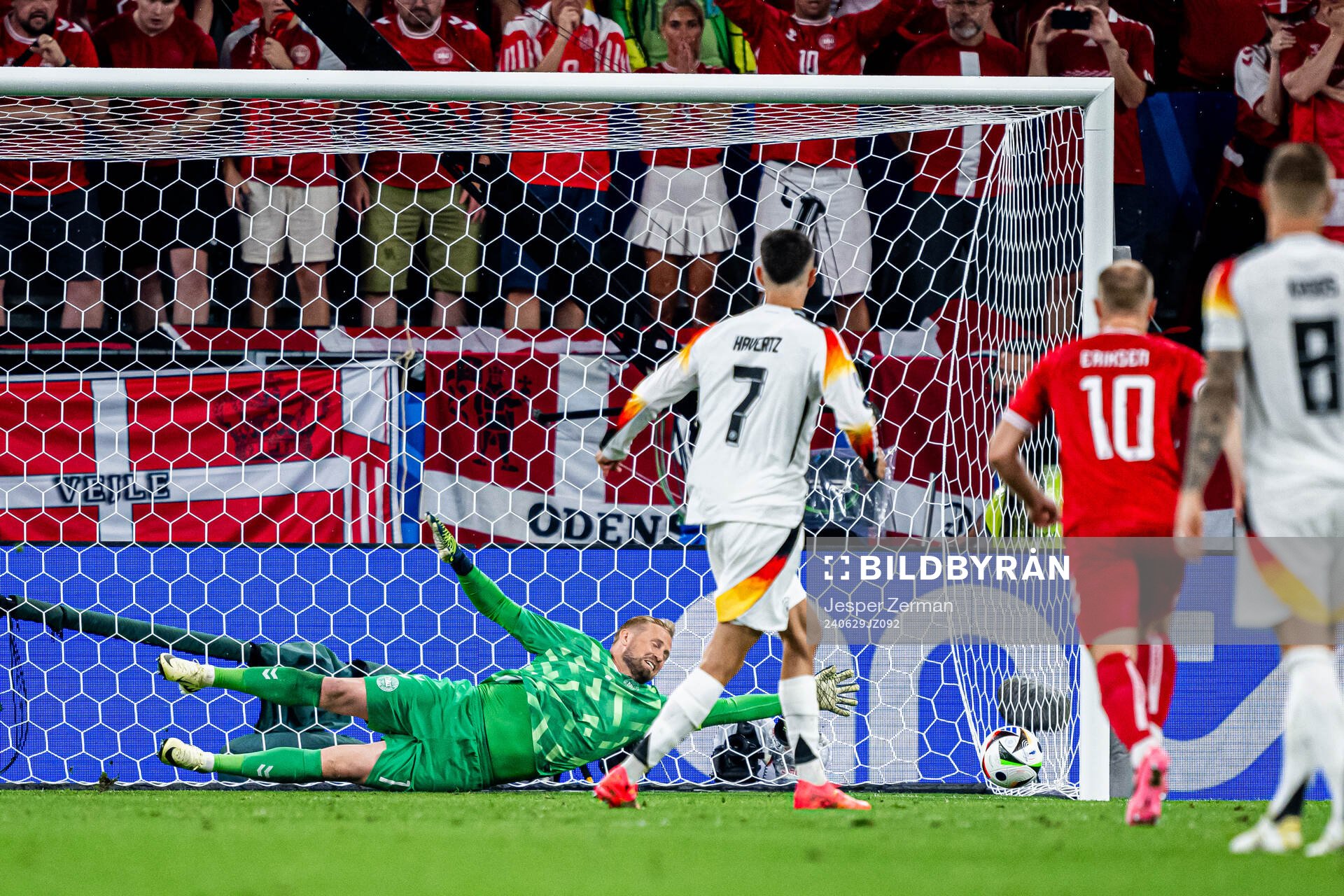 Kai Havertz of Germany scores 1-0 against goalkeeper Kasper Schmeichel of Denmark during the UEFA Euro 2024 Football Championship round of 16 match between Germany and Denmark on June 29, 2024 in Dortmund.