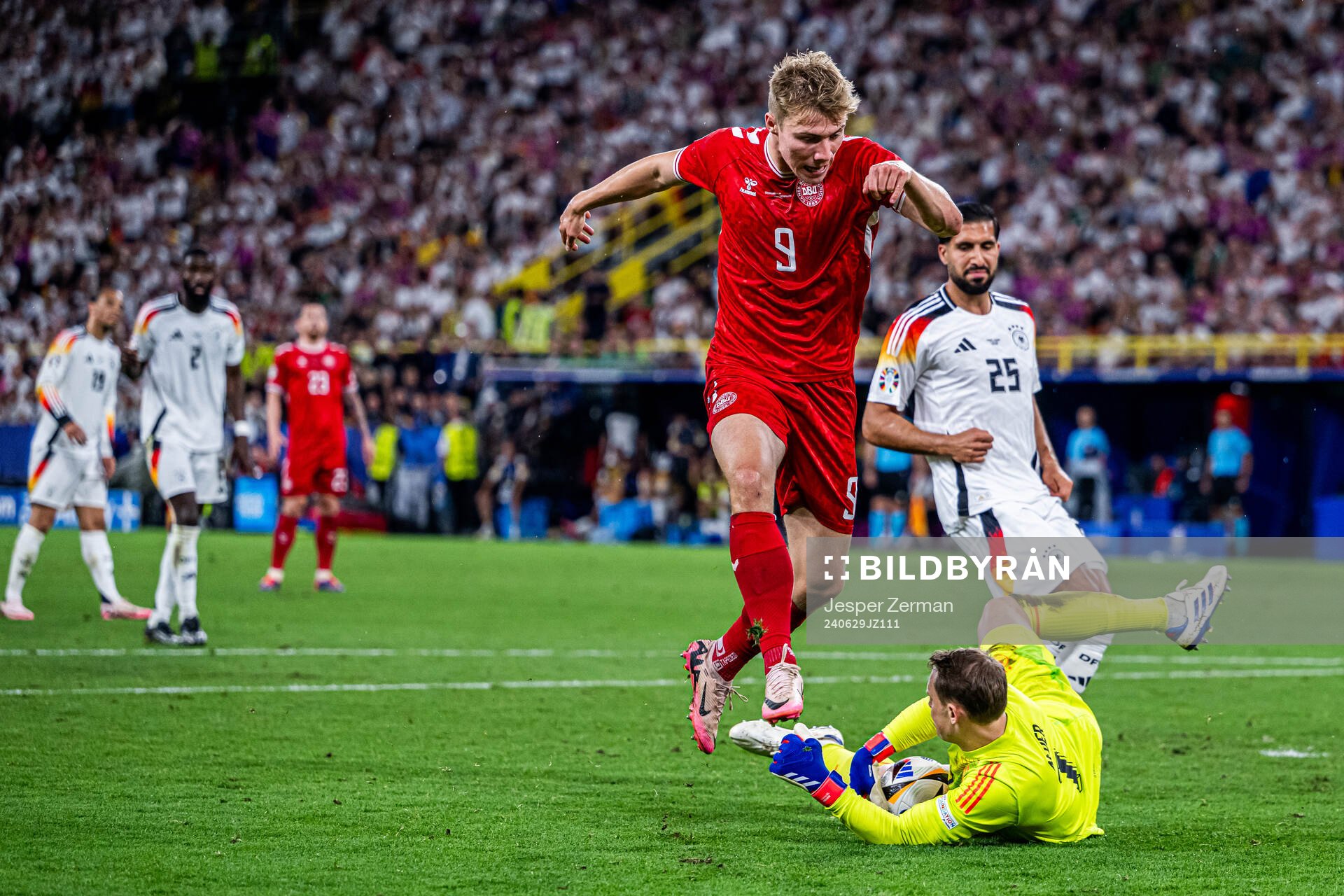 Rasmus Højlund of Denmark and Emre Can and goalkeeper