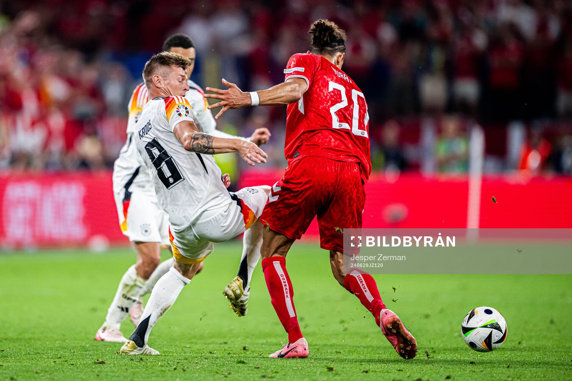 Toni Kroos of Germany and Yussuf Poulsen of Denmark