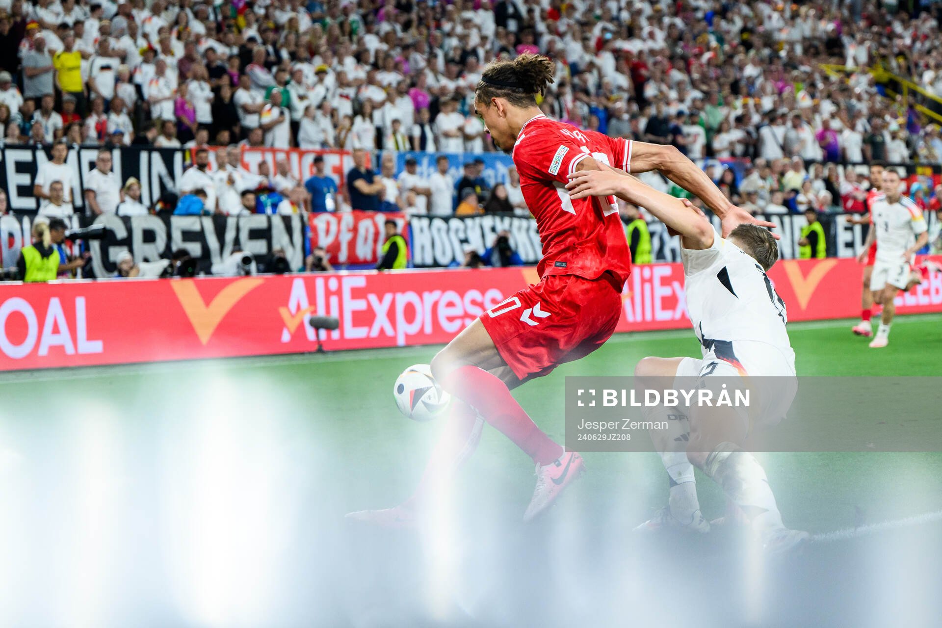 Yussuf Poulsen of Denmark and Nico Schlotterbeck of Germany