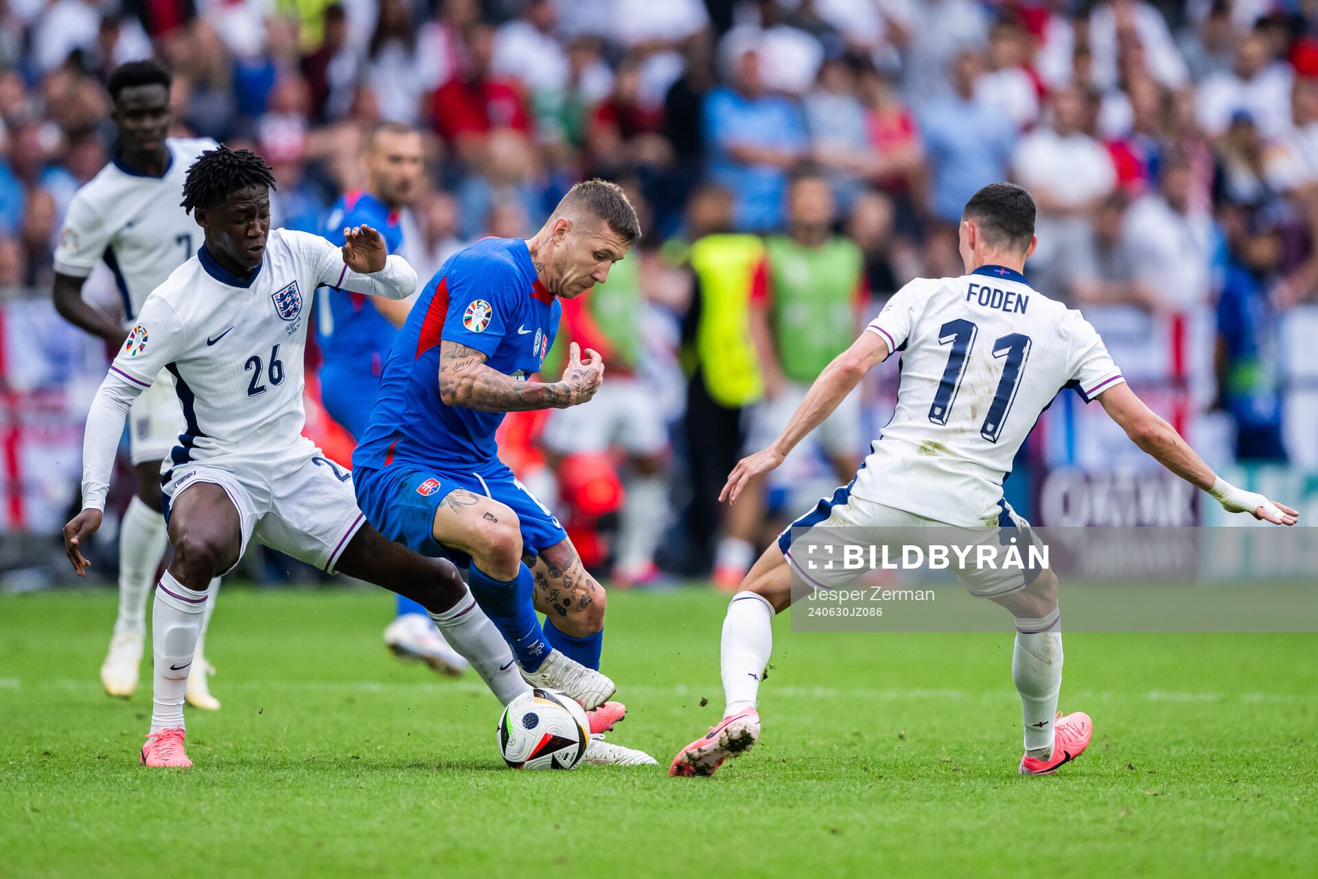 Juraj Kucka of Slovakia and Kobbie Mainoo and Phil Foden of