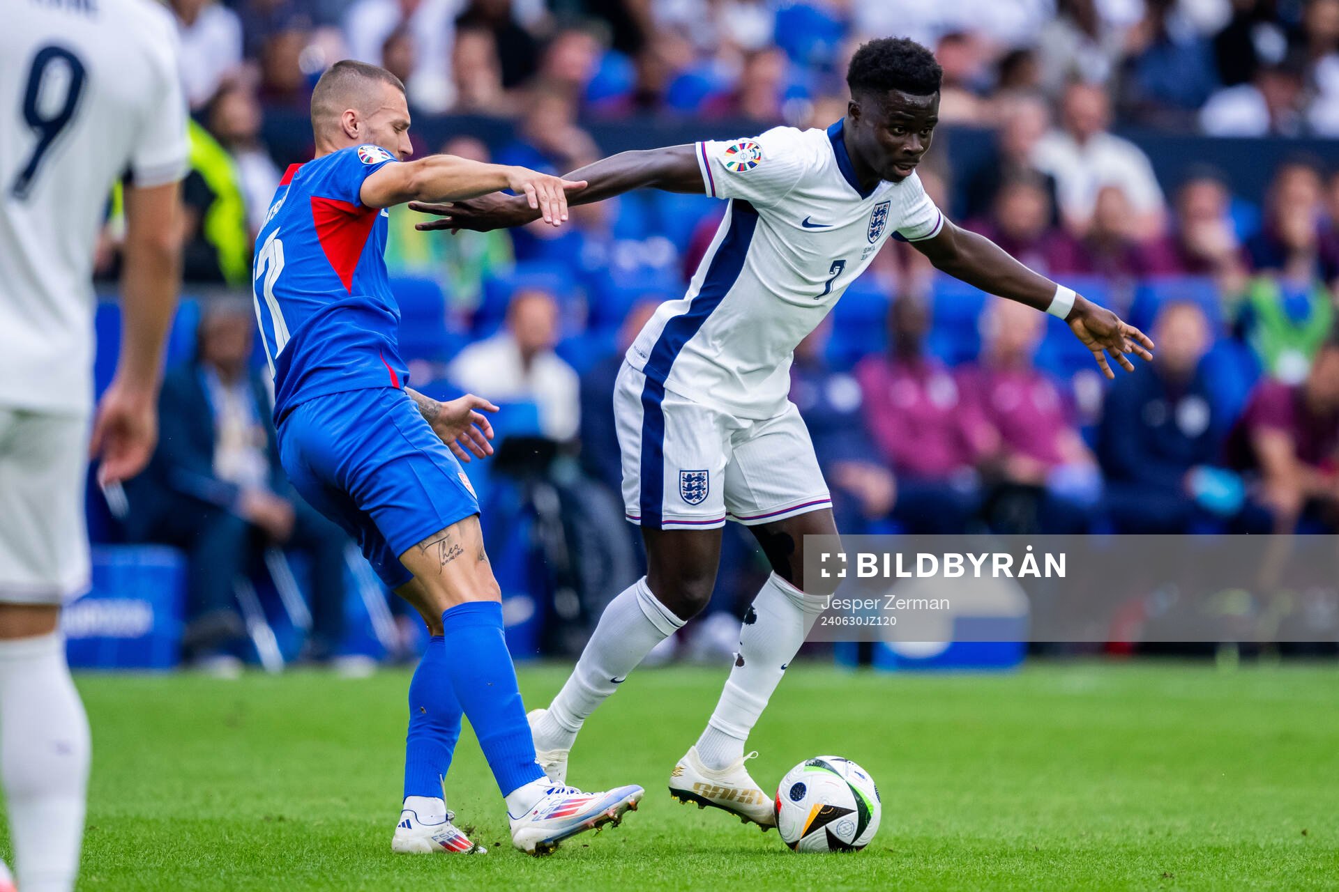 Lukas Haraslin of Slovakia and Bukayo Saka of England
