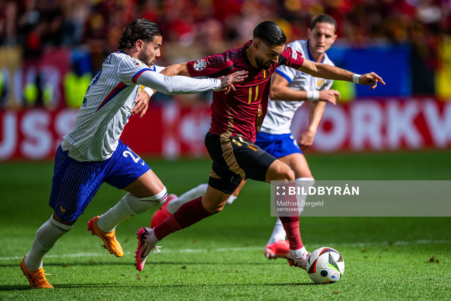Theo Hernandez of France and Yannick Carrasco of Belgium