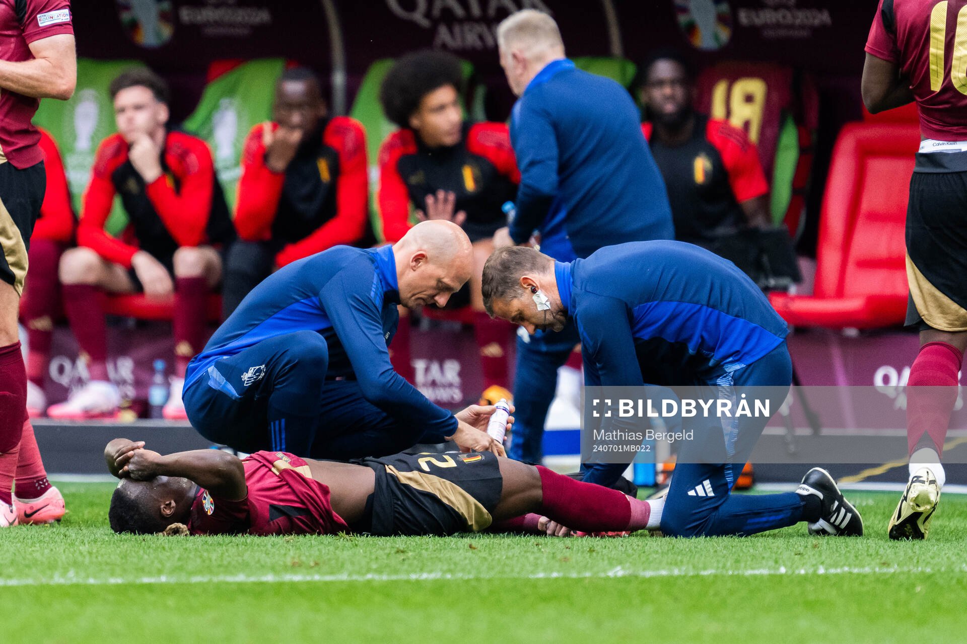 Jeremy Doku of Belgium receives care