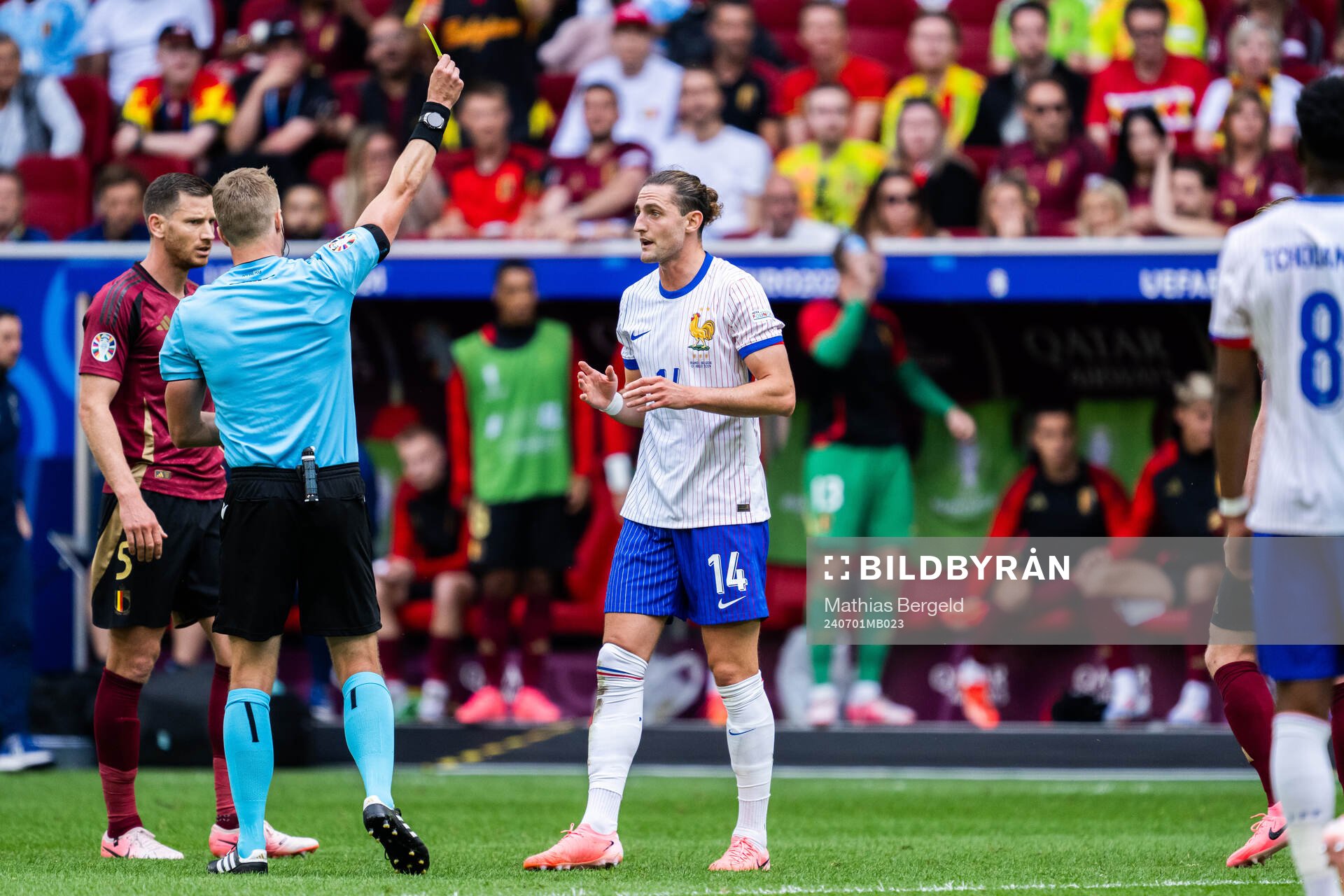 Referee Glenn Nyberg gives Adrien Rabiot of France a warning