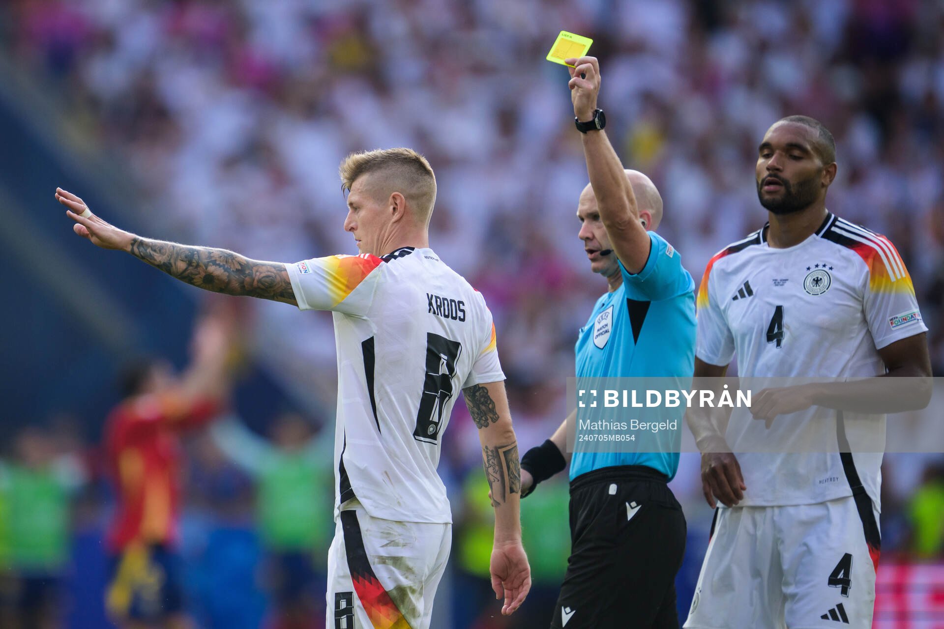 Toni Kroos of Germany receives a yellow card from referee