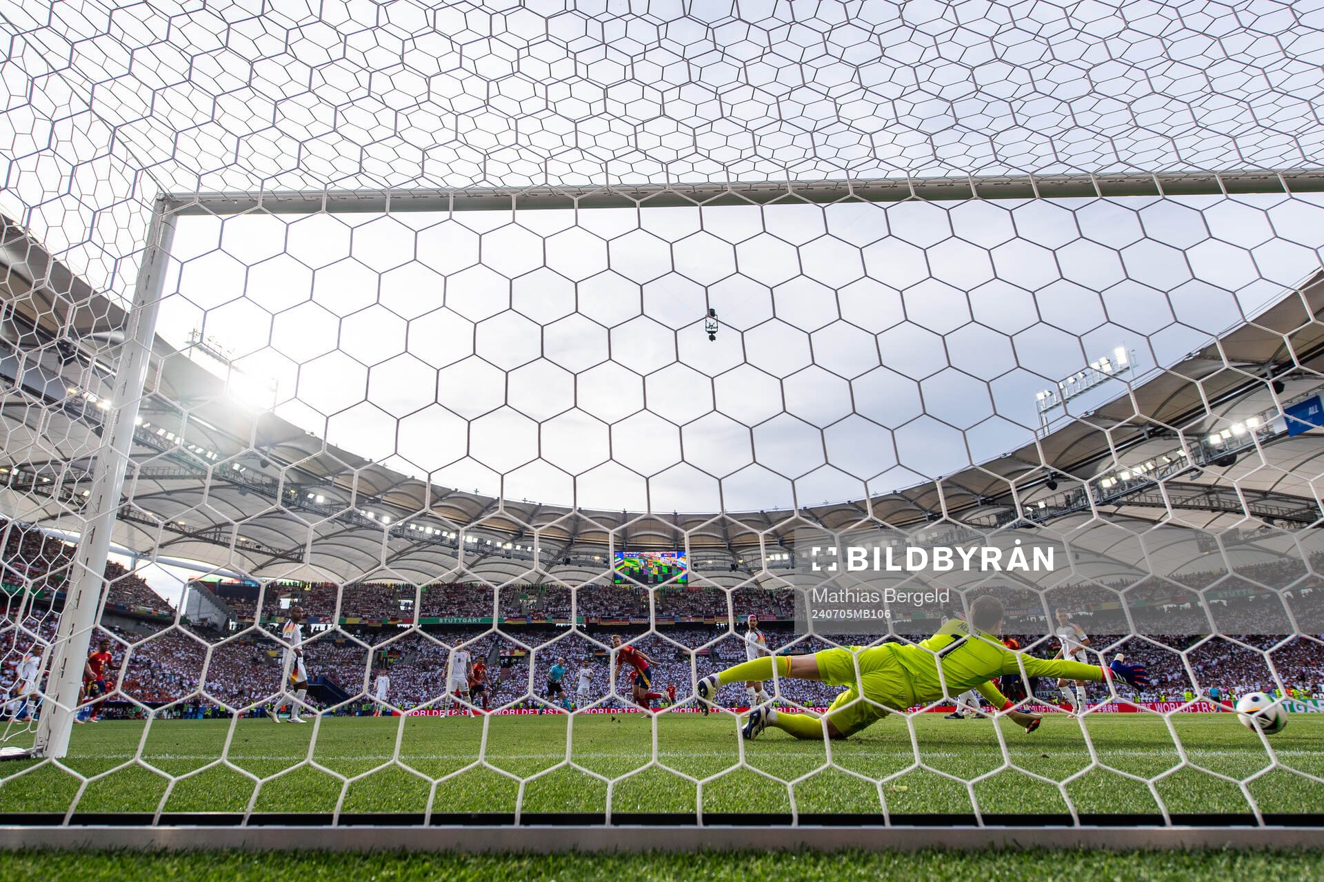 Daniel Olmo of Spain scores 1-1 behind goalkeeper Manuel