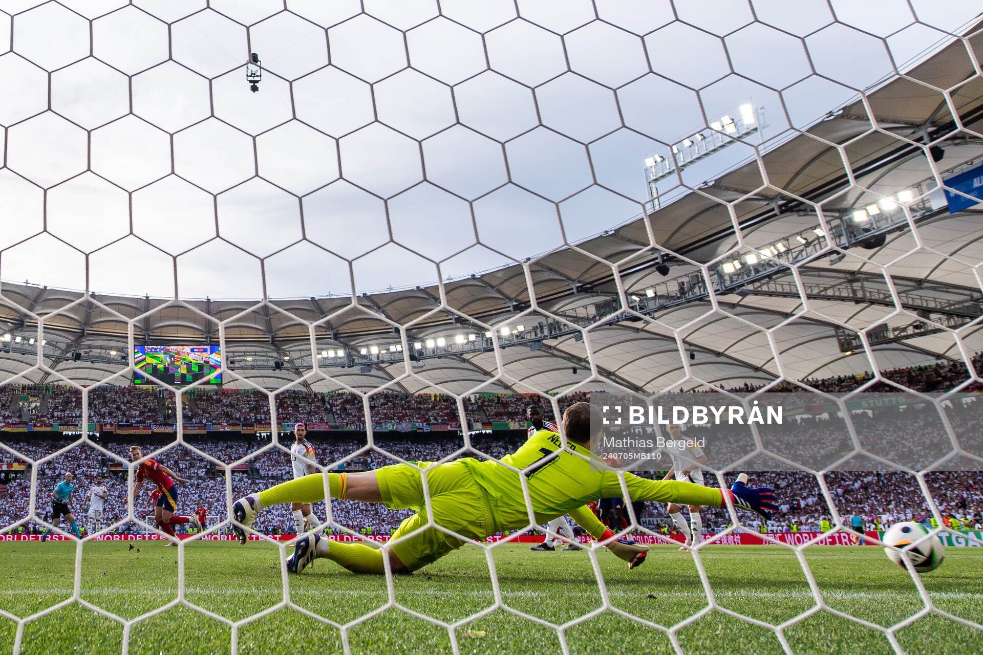 Daniel Olmo of Spain scores 1-1 behind goalkeeper Manuel