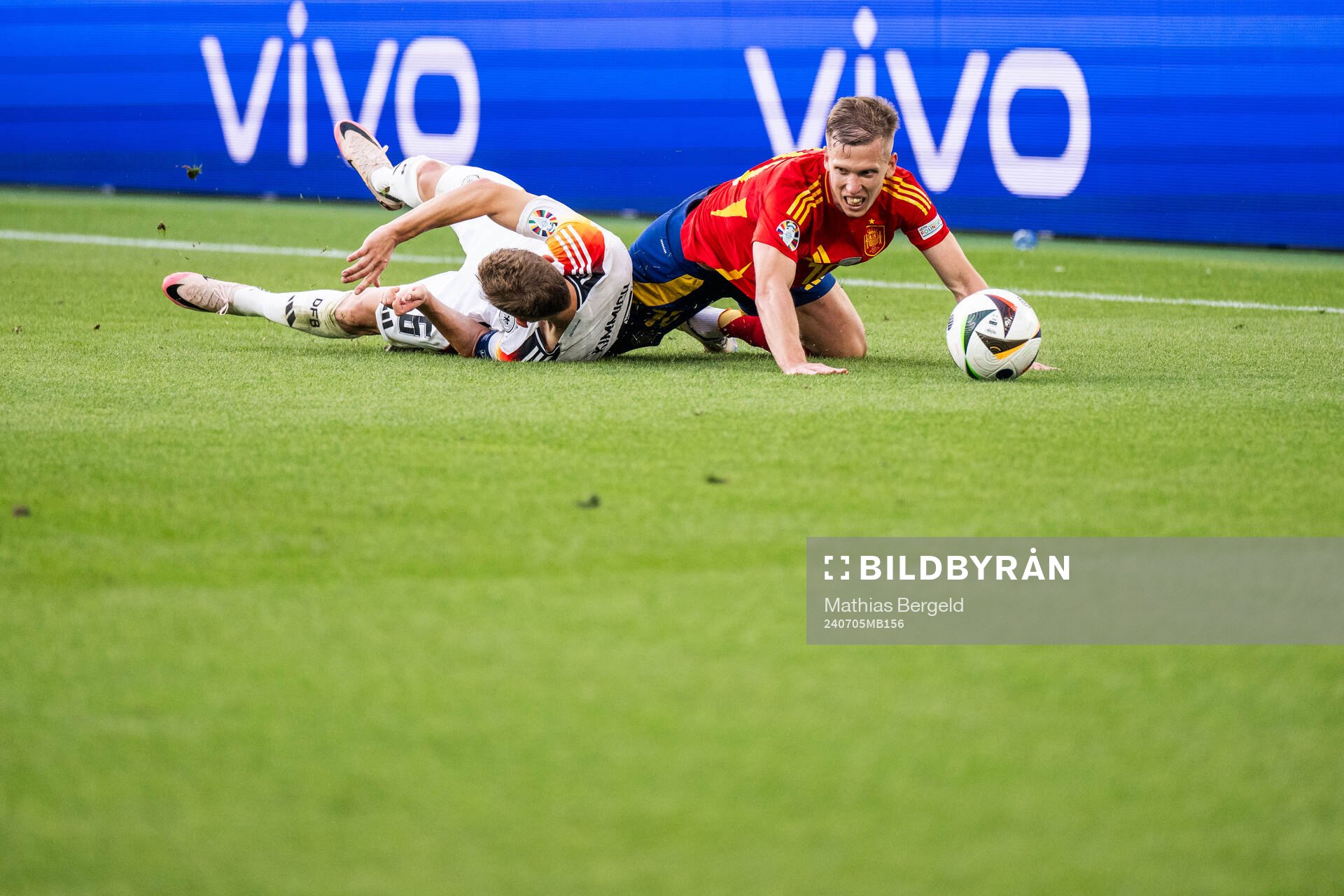 Joshua Kimmich of Germany and Daniel Olmo of Spain compete