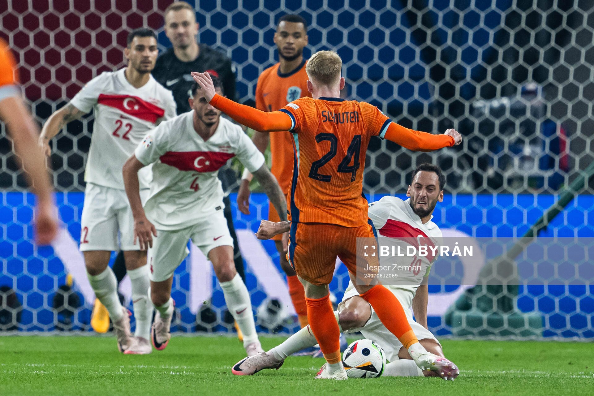 Jerdy Schouten of Netherlands and Hakan Calhanoglu of Turkey