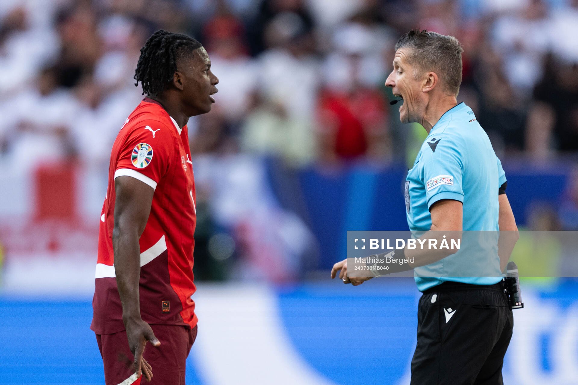 Breel Embolo of Switzerland and referee Daniele Orsato