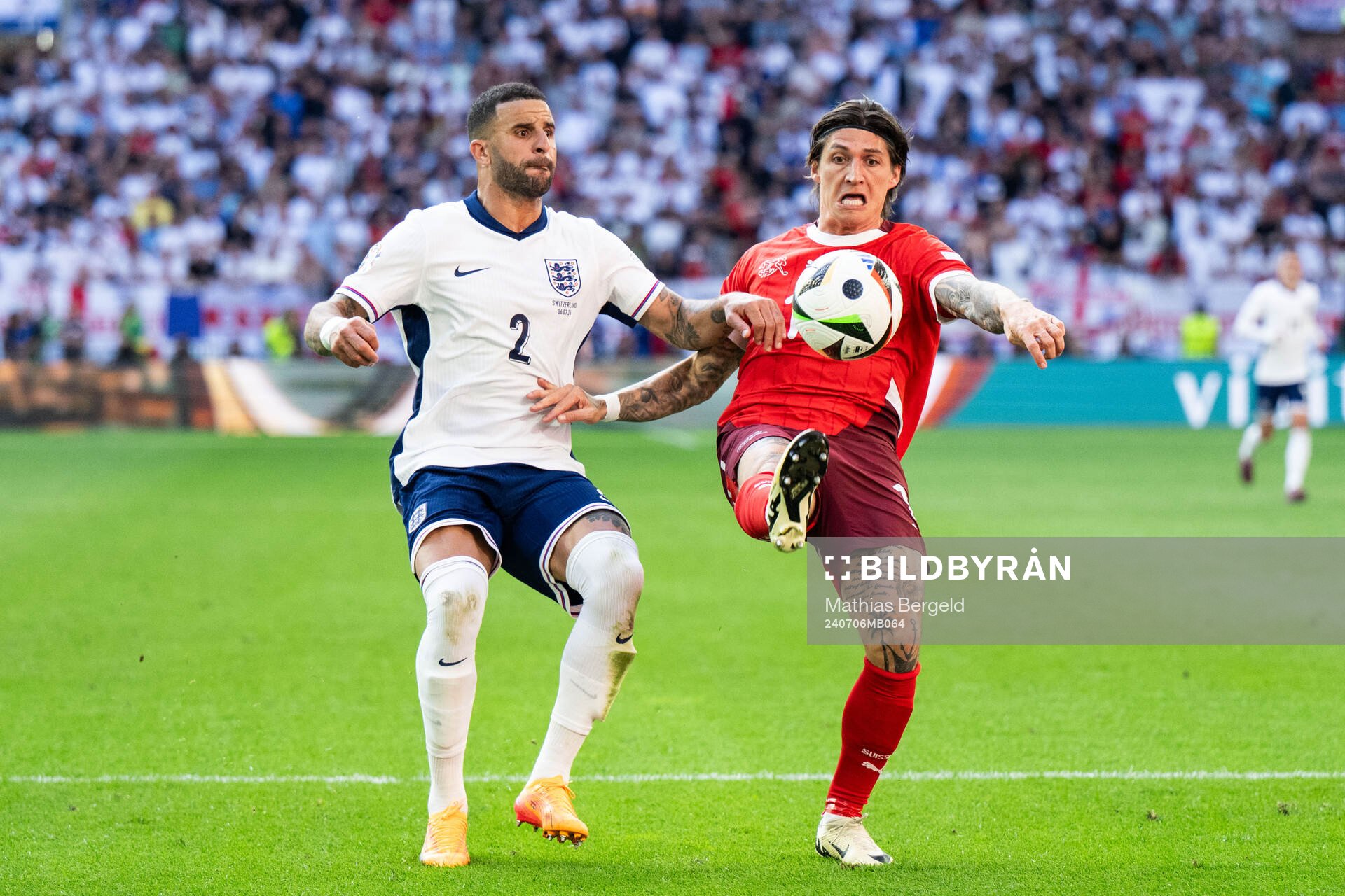 Kyle Walker of England and Steven Zuber of Switzerland