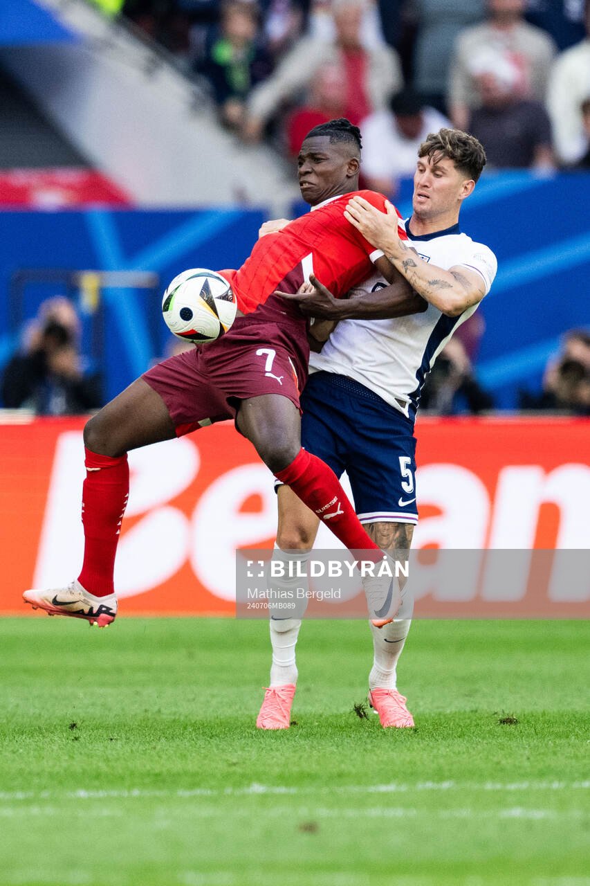 Breel Embolo of Switzerland and John Stones of England