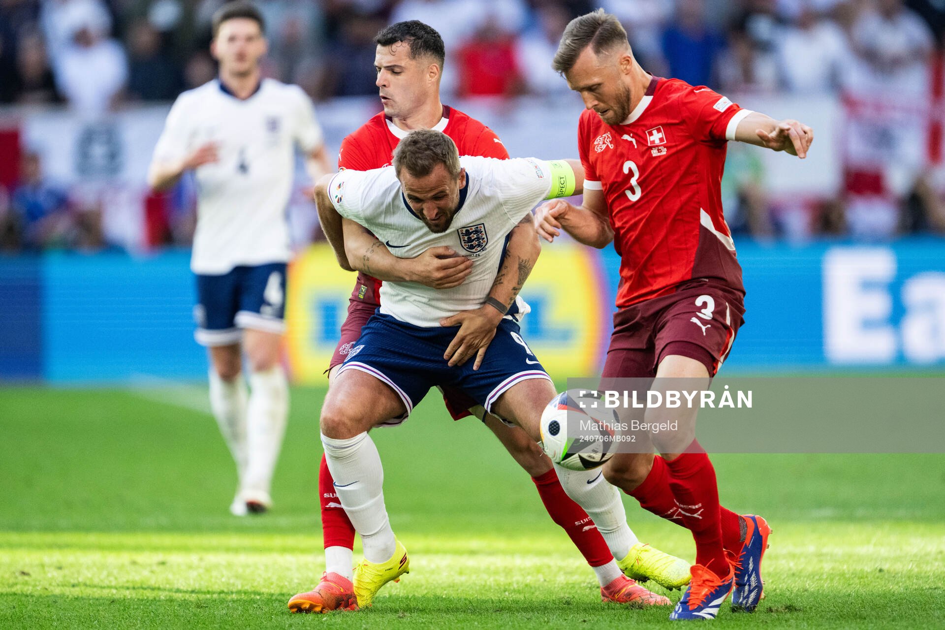 Granit Xhaka and Silvan Widmer of Switzerland against Harry Kane of England during the UEFA Euro 2024 Football Championship quarterfinal between England and Switzerland on July 6, 2024 in Düsseldorf.