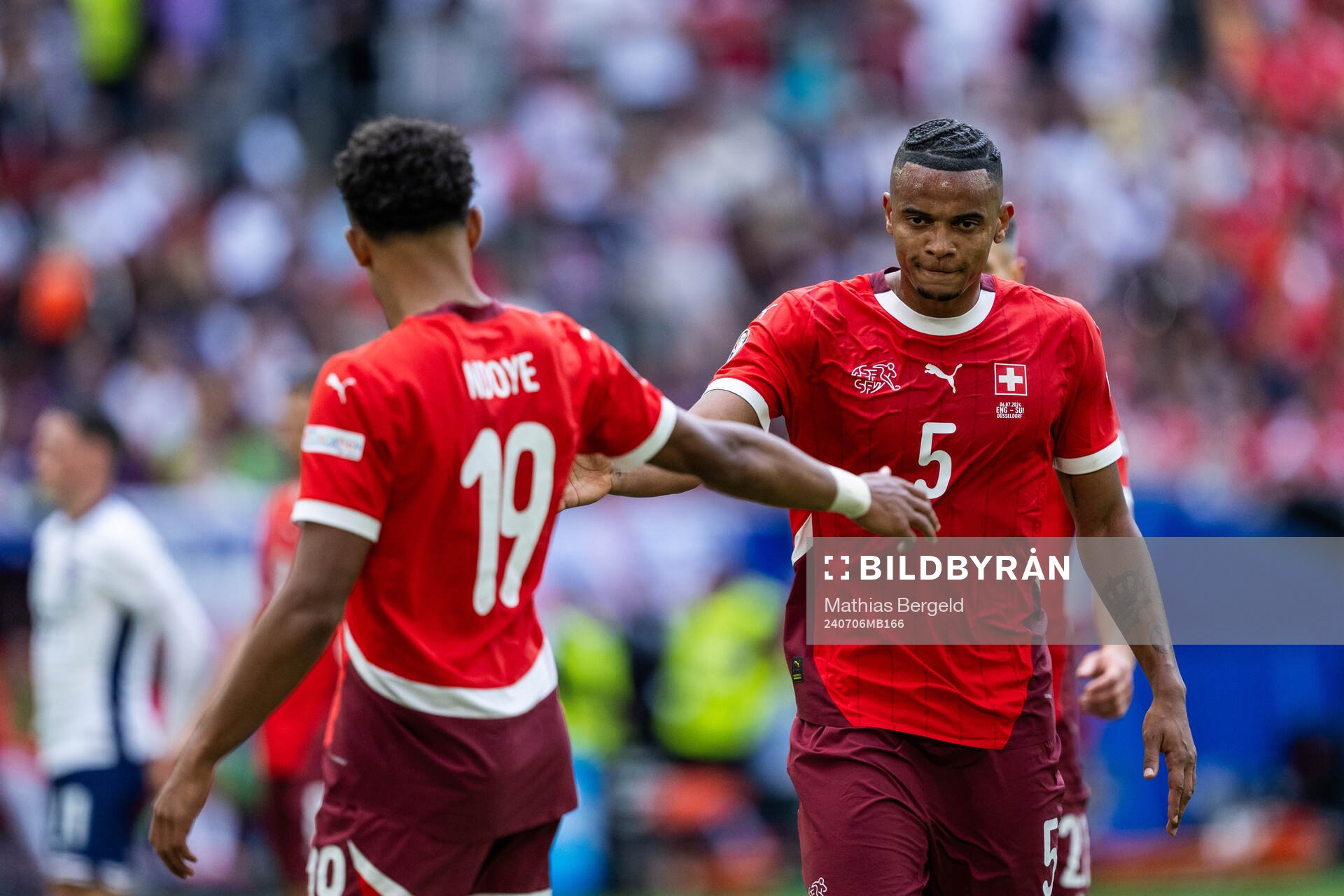 Dan Ndoye and Manuel Akanji of Switzerland