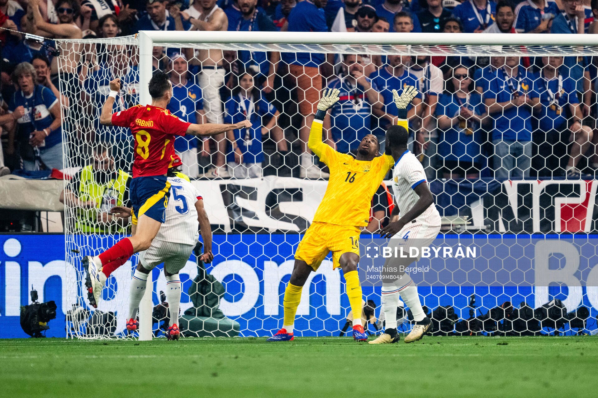 Fabian Ruiz Pena of Spain against goalkeeper Mike Maignan of France during the UEFA Euro 2024 Football Championship semifinal between Spain and France on July 9, 2024 in Munich.