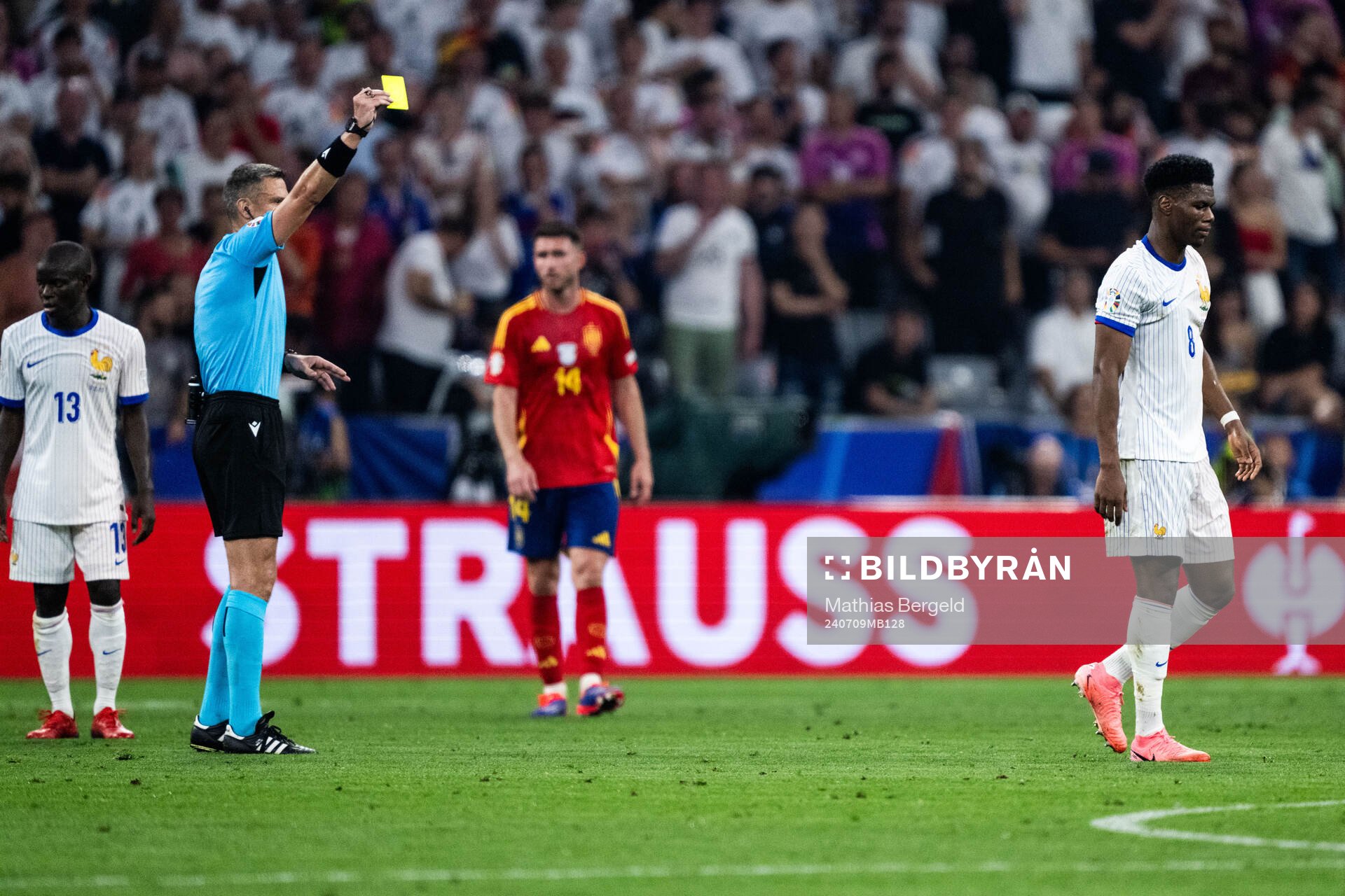 Aurélien Tchouameni of France receives a yellow card from