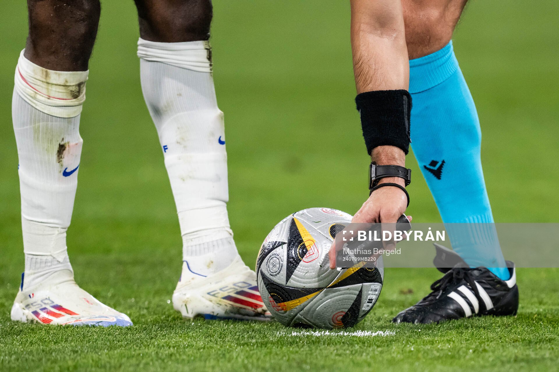 Referee Slavko Vincic sprays next to the ball