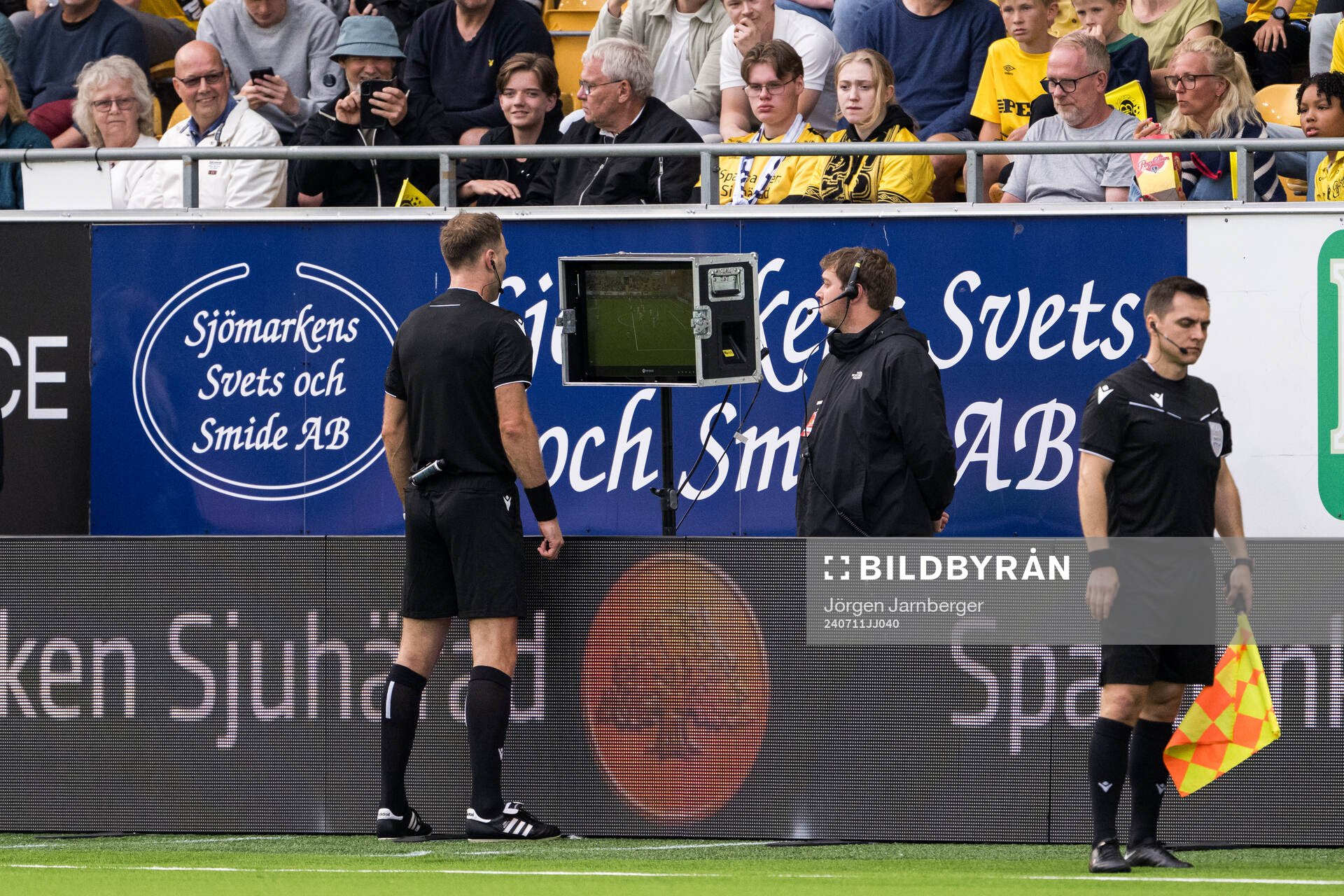 Referee Dmytro Panchyshyn checking the VAR monitor
