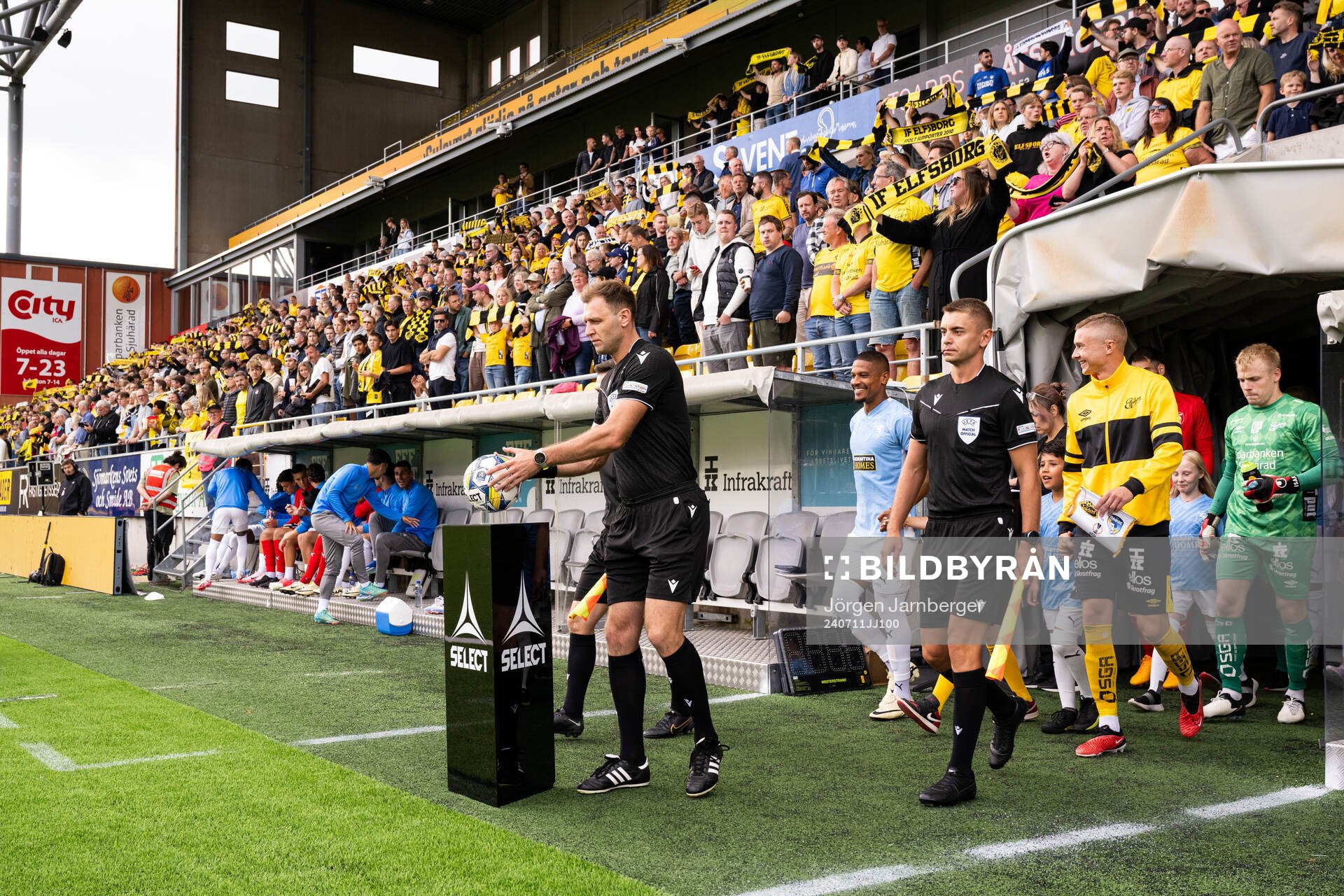 Referees and players enter the field