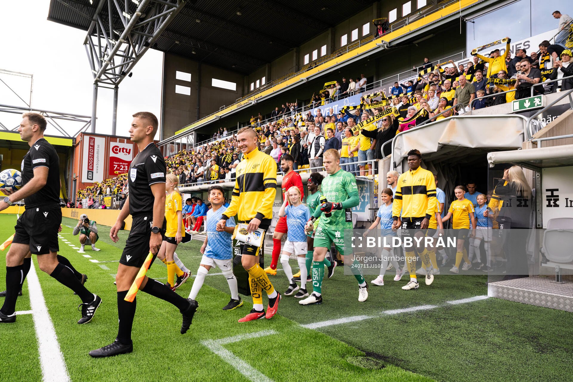 Referees and players enter the field