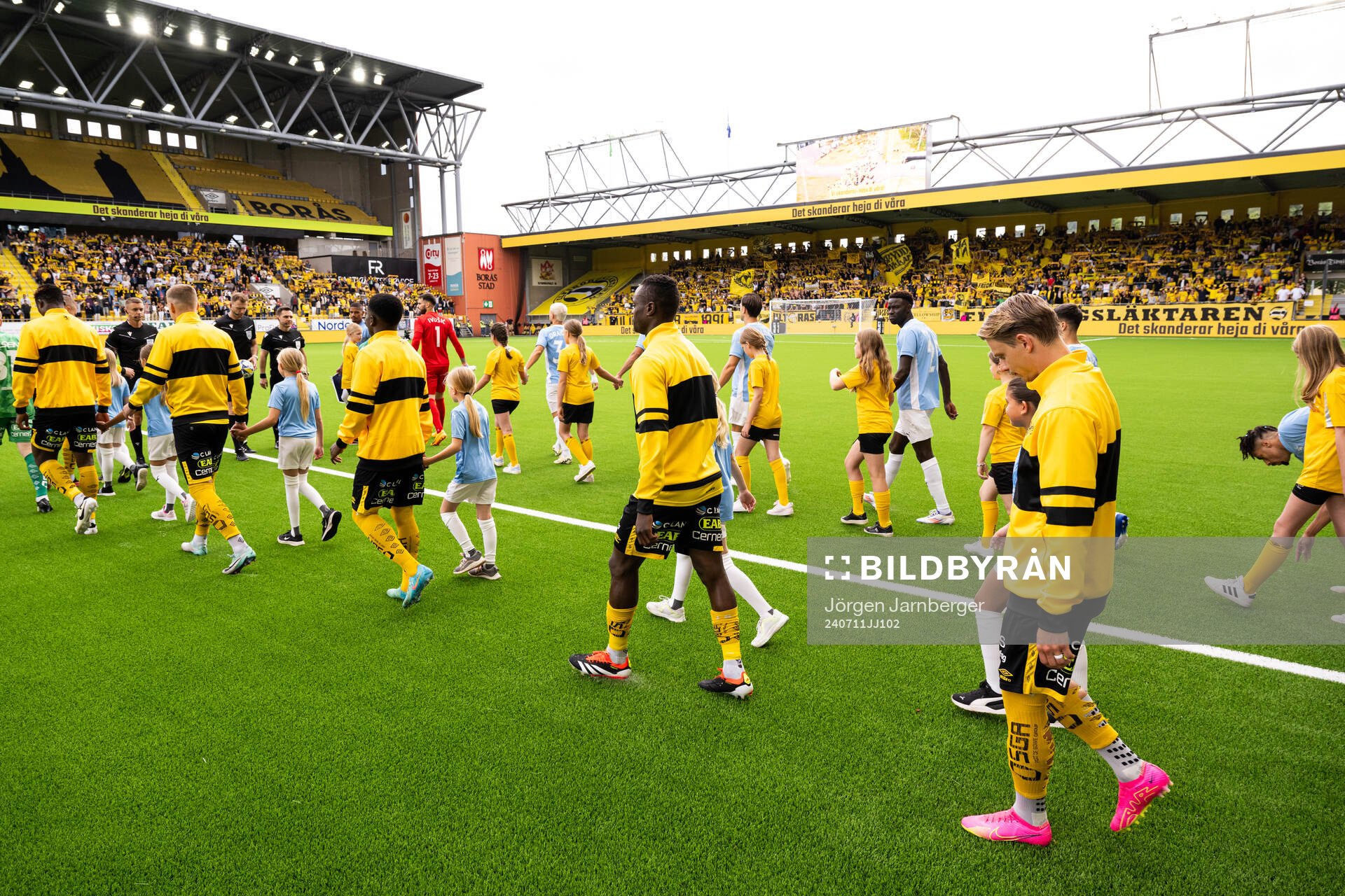 Referees and players enter the field