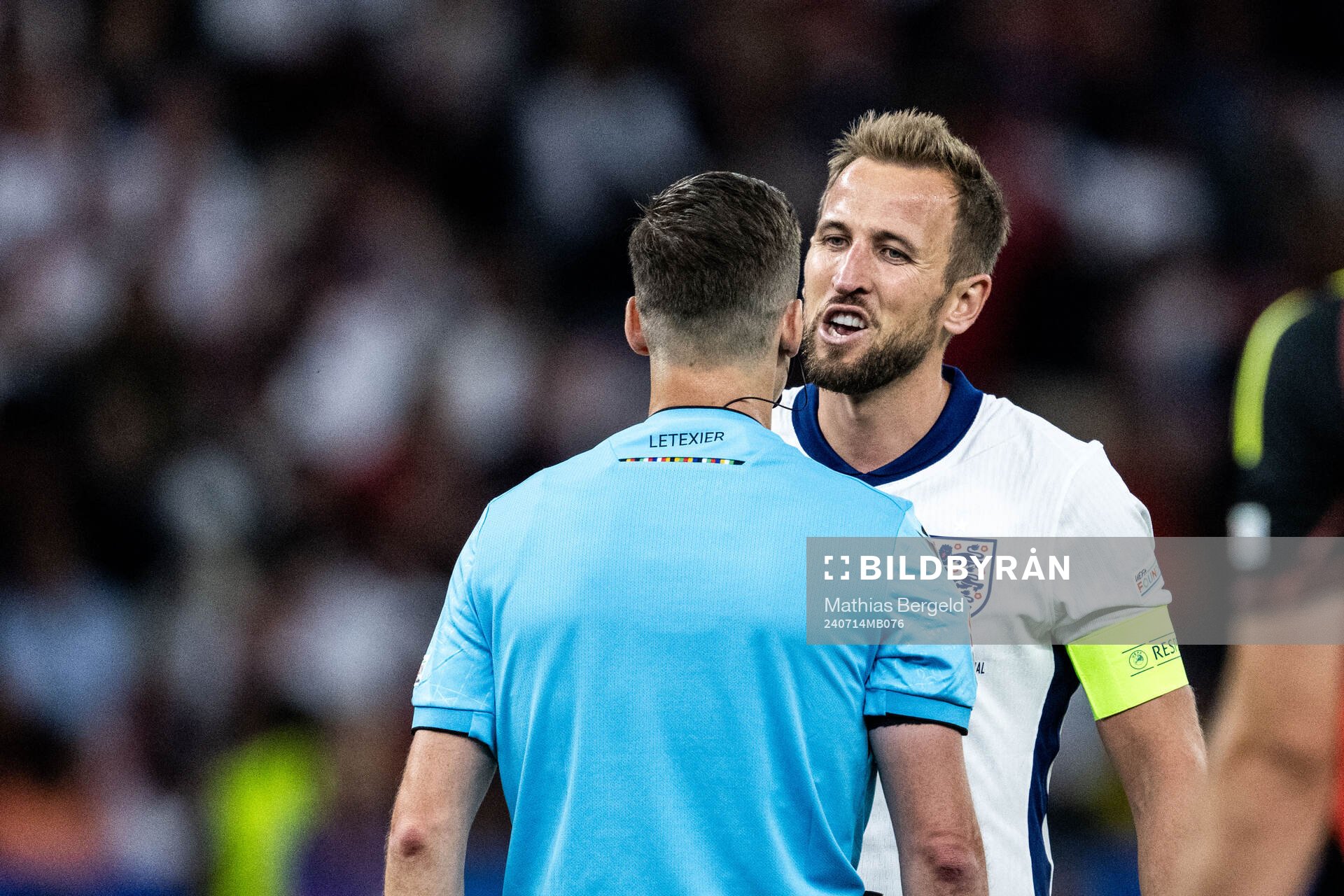 Harry Kane of England talks to referee Francois Letexier