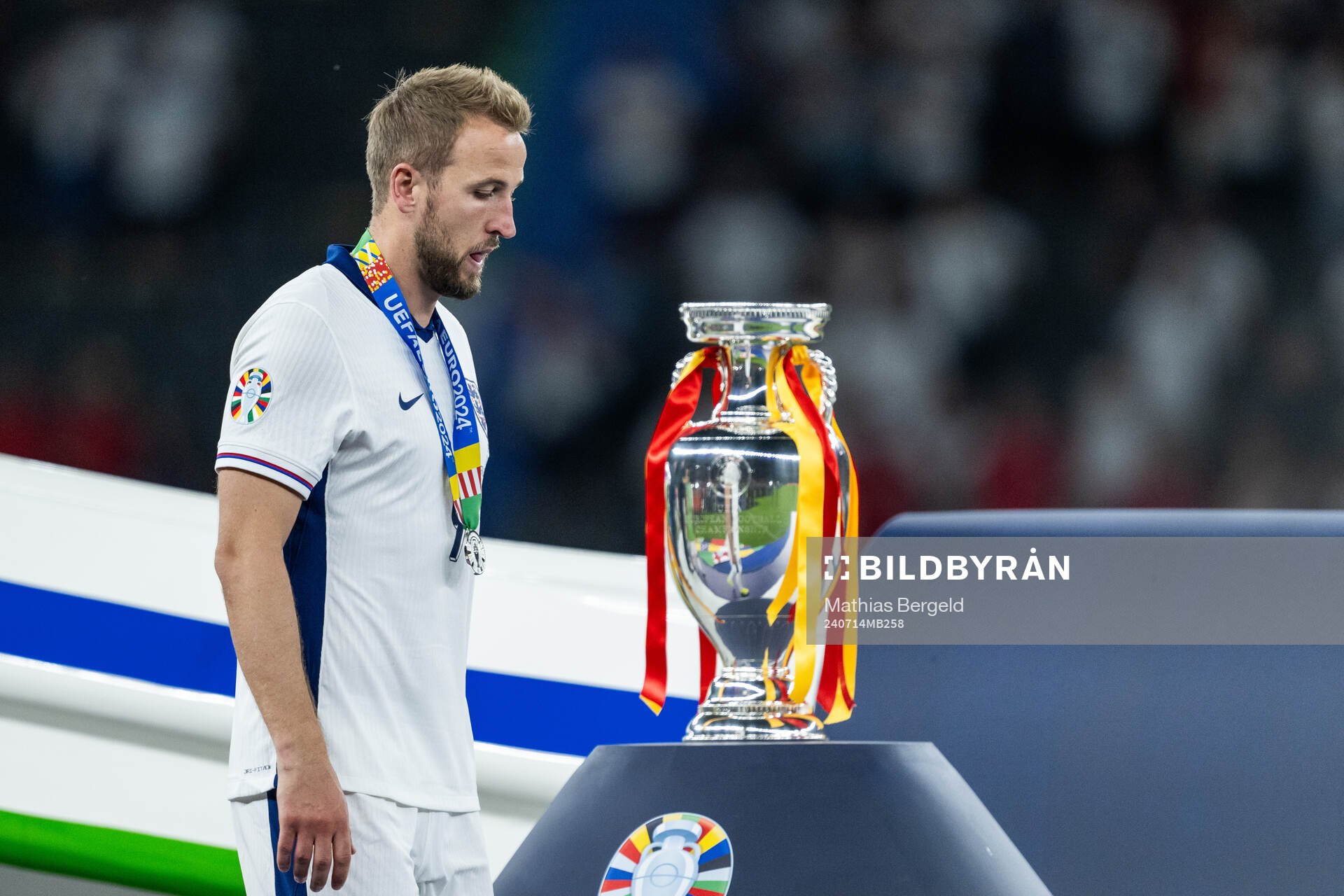 Harry Kane of England looks dejected as he walks past the