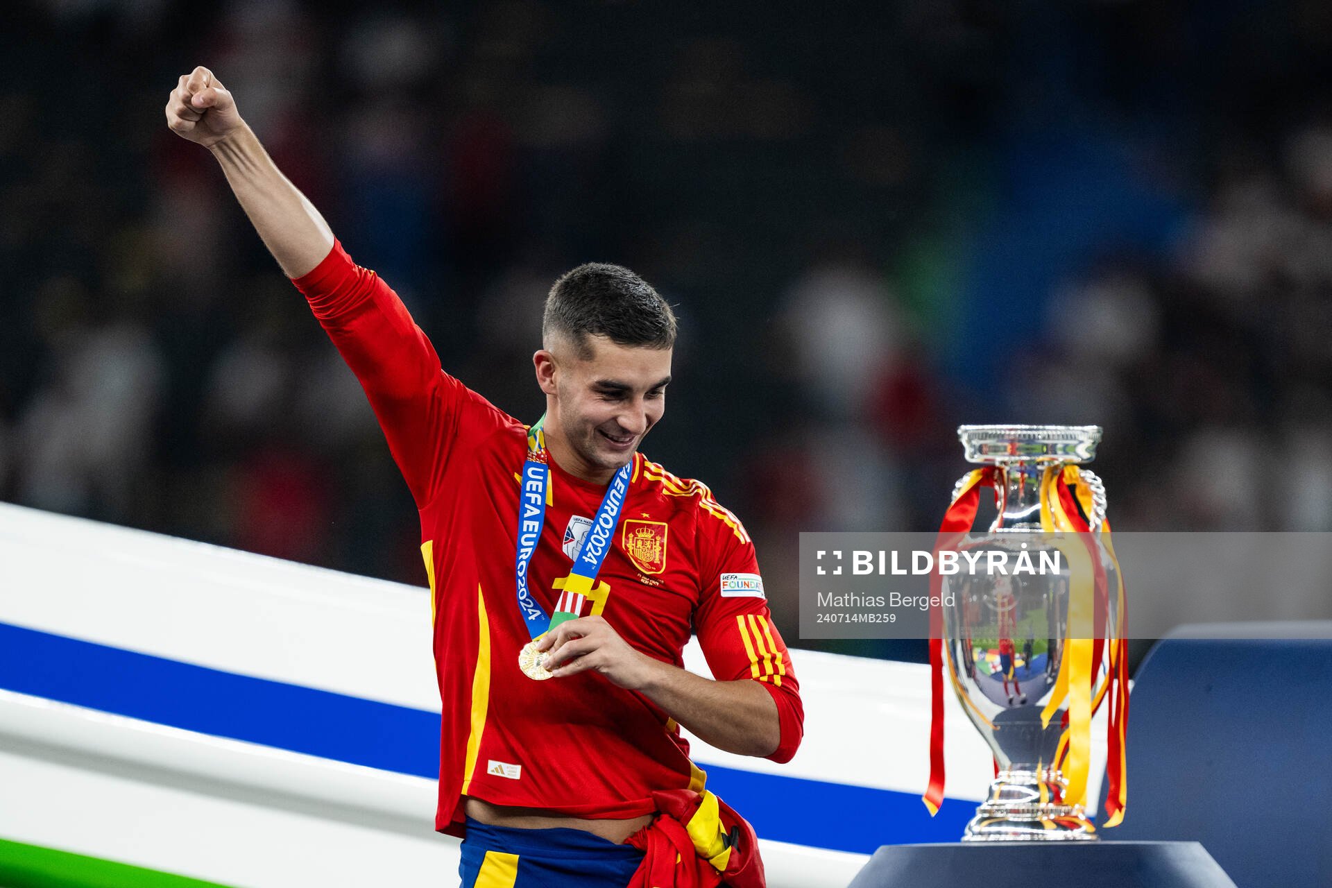 Ferran Torres of Spain celebrates next to the trophy