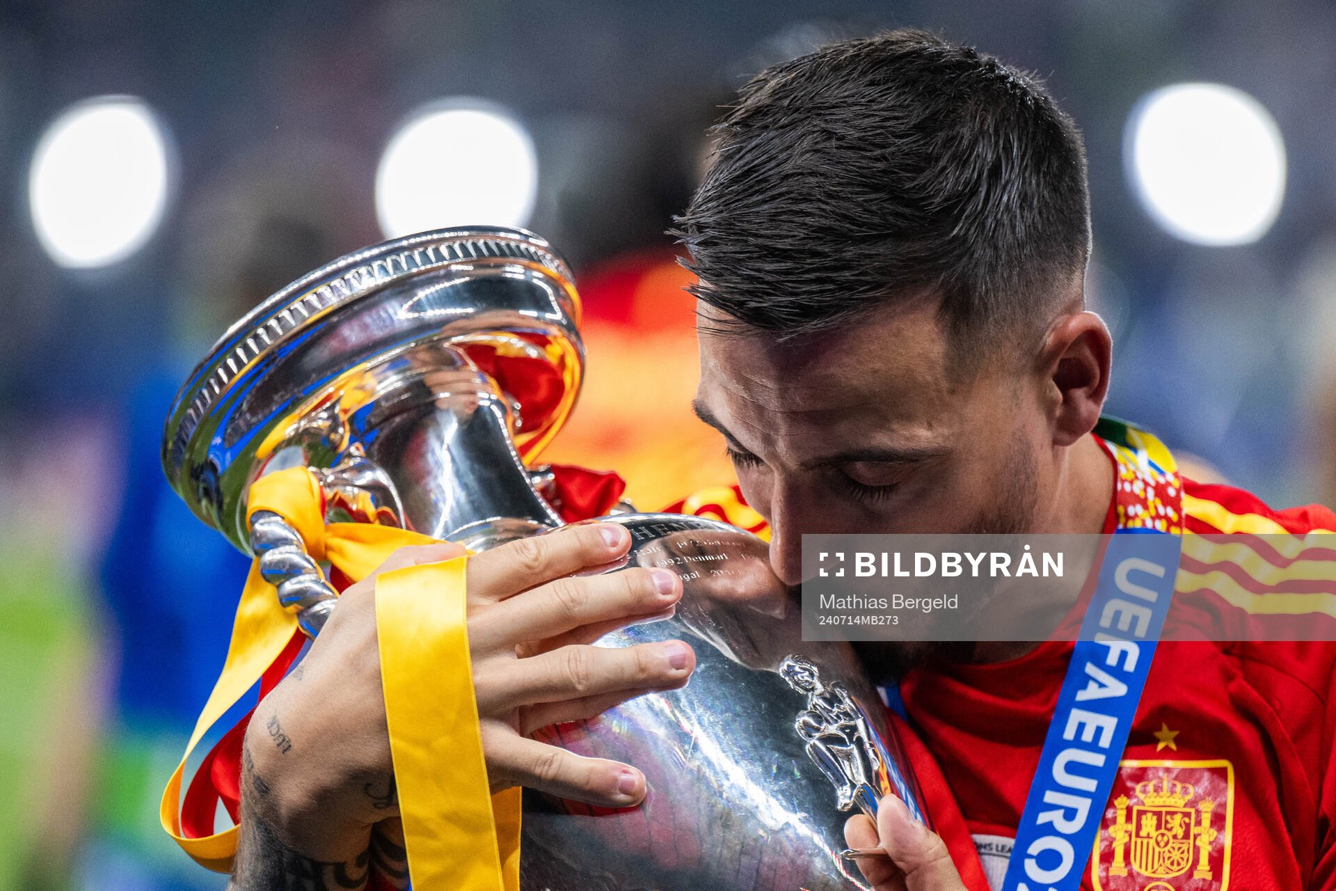 Joselu of Spain celebrates with the trophy
