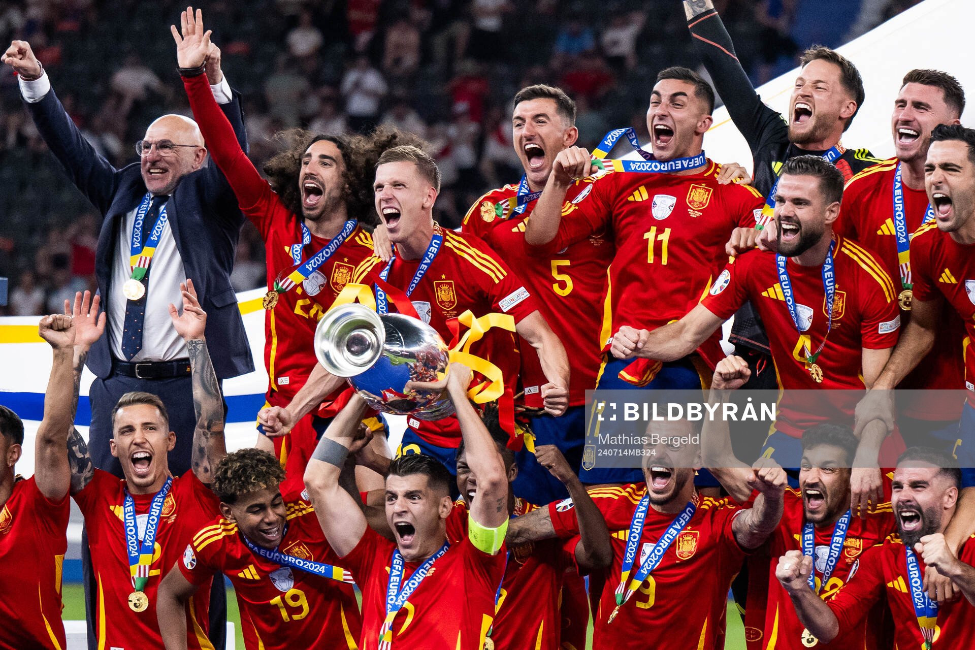 Alvaro Morata of Spain celebrates with the trophy in front