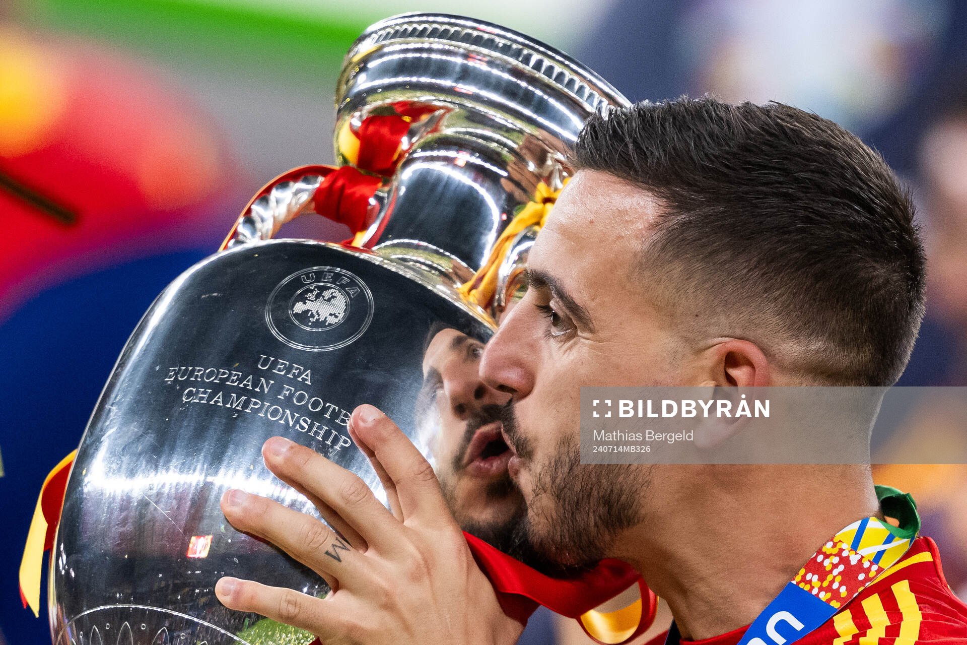 Joselu of Spain celebrates with the trophy