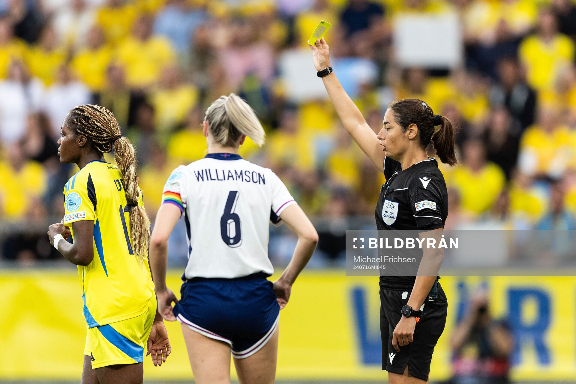 Evelyn Ijeh of Sweden receives a yellow card from Referee