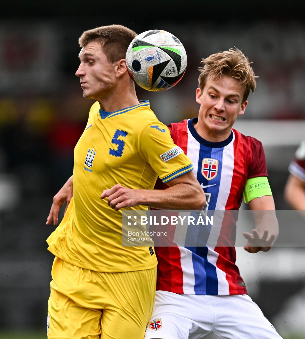 Mykola Oharkov of Ukraine is tackled by Benjamin Thoresen