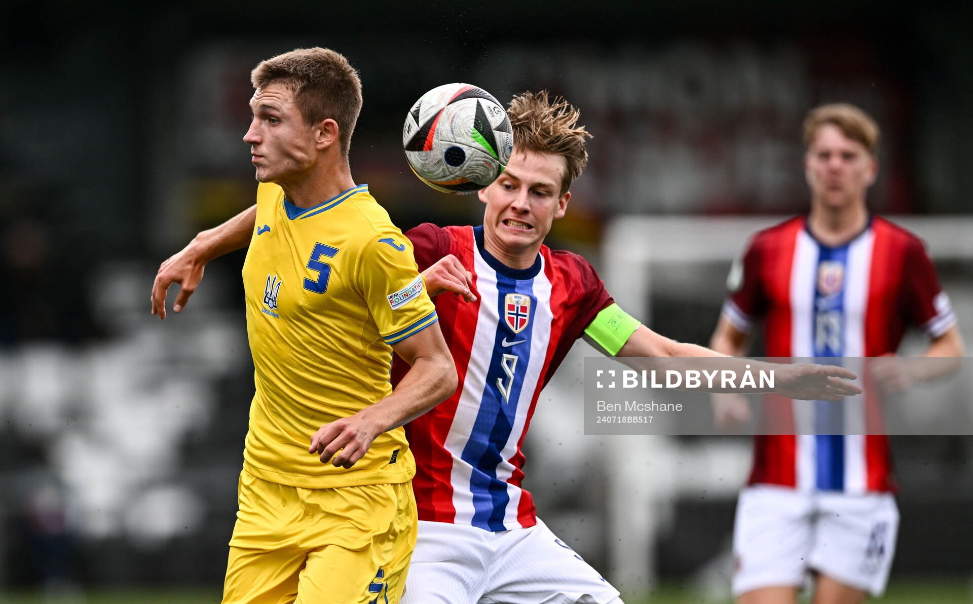 Mykola Oharkov of Ukraine is tackled by Benjamin Thoresen