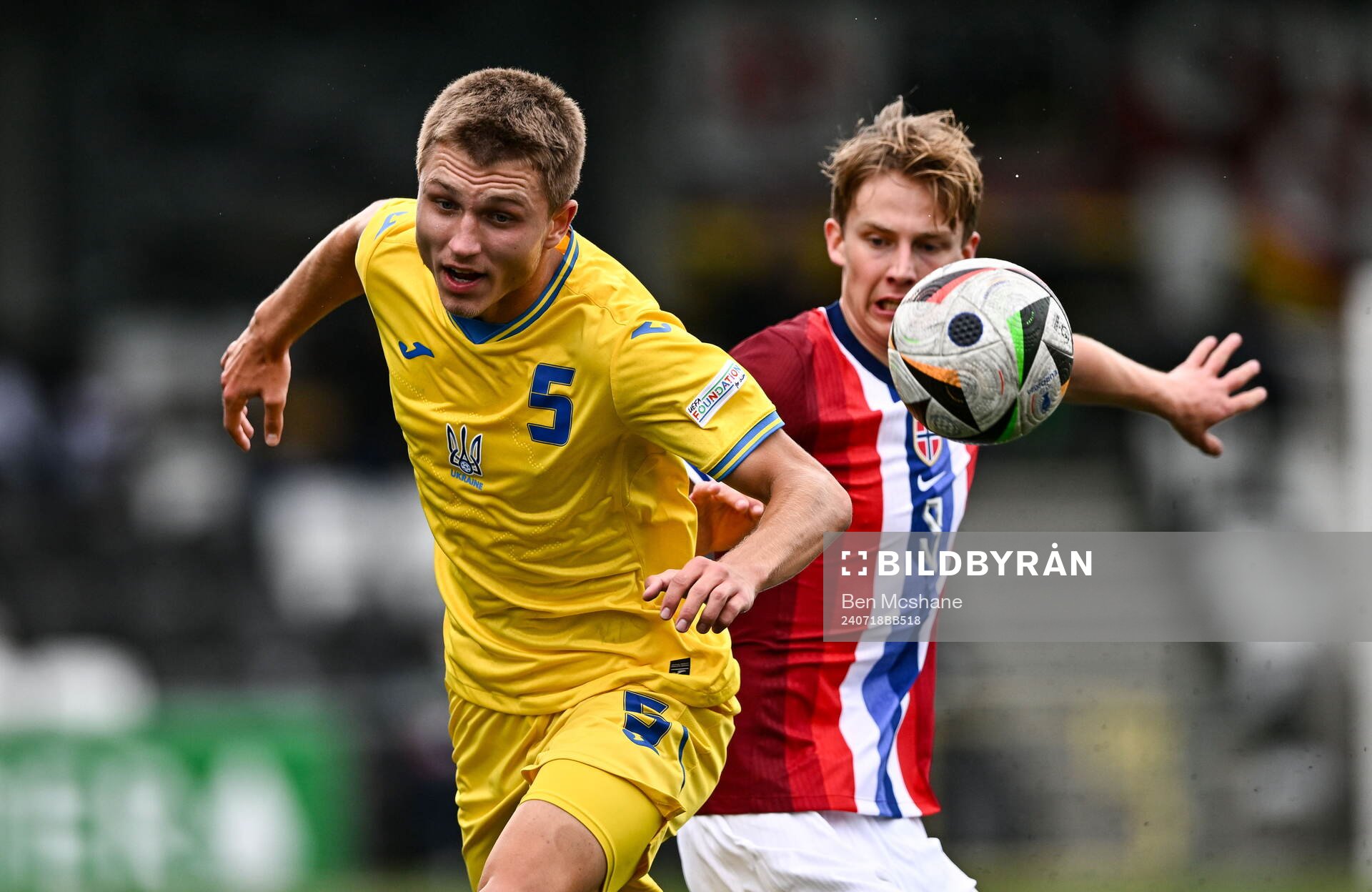 Mykola Oharkov of Ukraine is tackled by Benjamin Thoresen