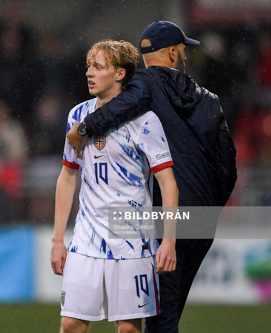 Sondre Granaas of Norway is hugged by head coach Luis