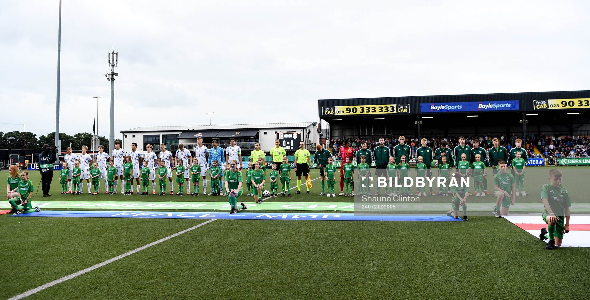Both teams stand for the playing of the national anthems