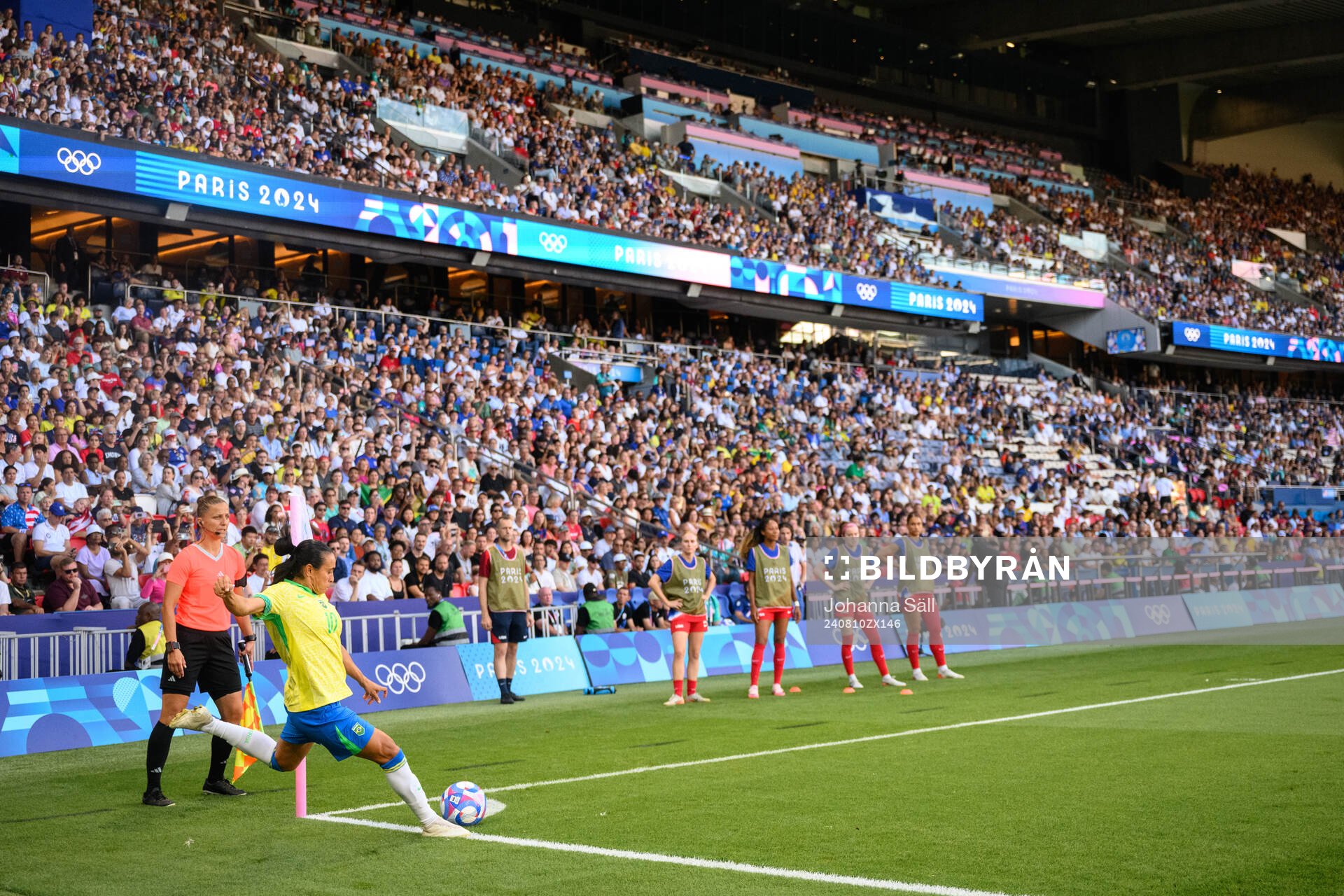 Marta of Brazil and assistant referee Almira Spahic in the
