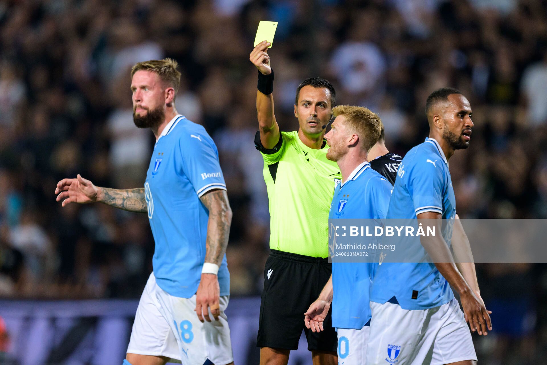 Pontus Jansson of Malmö FF receives a yellow card from