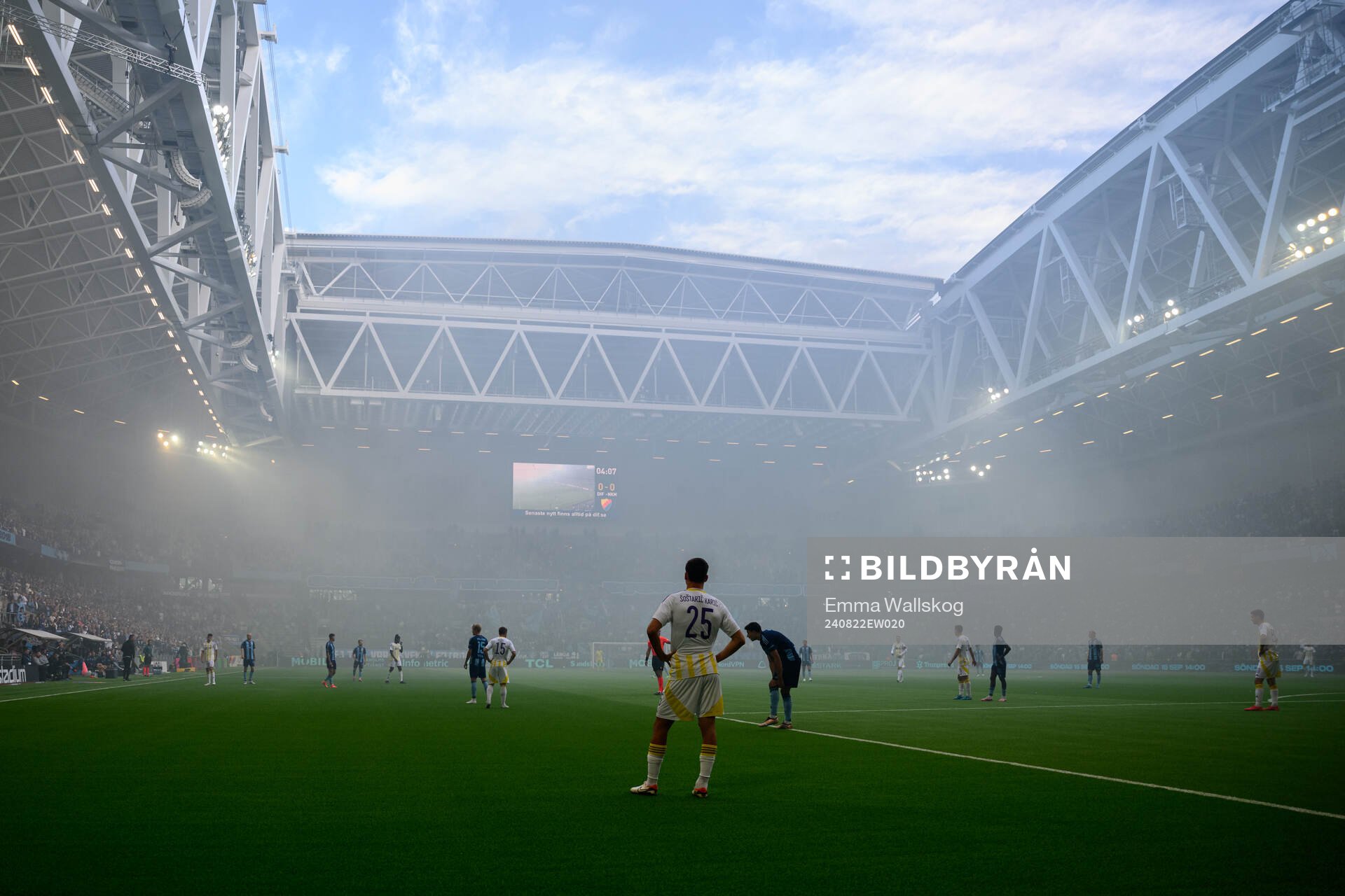 The referee pauses the game due to smoke in the arena