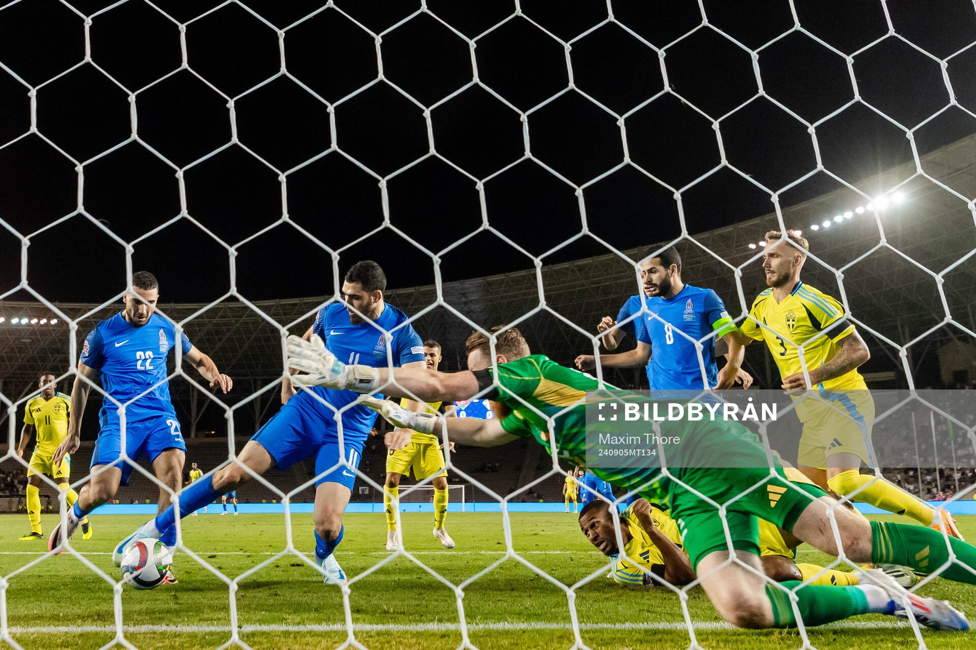 Emin Makhmudov of Azerbaijan and goalkeeper Viktor